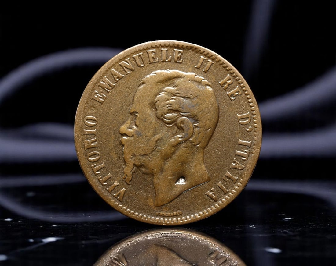 ITALY: Vittorio Emanuele II - National Unification 10 Centesimi Coin, 1867 H, 29mm: Struck in 1867 at the mint of Birmingham (denoted by the "H" for Heaton), this 10 Centesimi coin represents the industrial support behind Italy's unification movement. The left-facing bust of King Vit