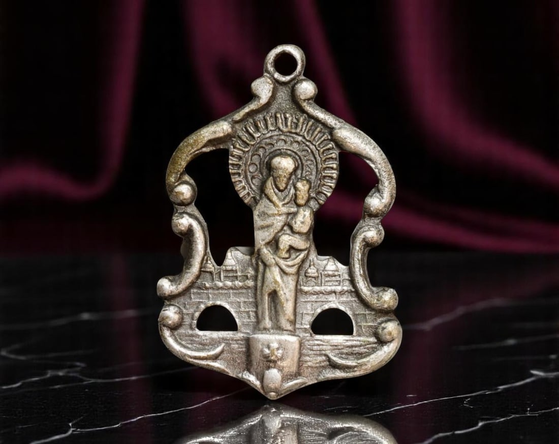 SPAIN: Virgin of Montserrat - Baroque Devotional Medal with Architectural Motif Coin, c.1940s, 24mm: A captivating tribute to Catalonia's spiritual icon, this pierced-frame devotional medal presents the enthroned Virgin of Montserrat with the Christ Child, set against a stylized backdrop of monastery