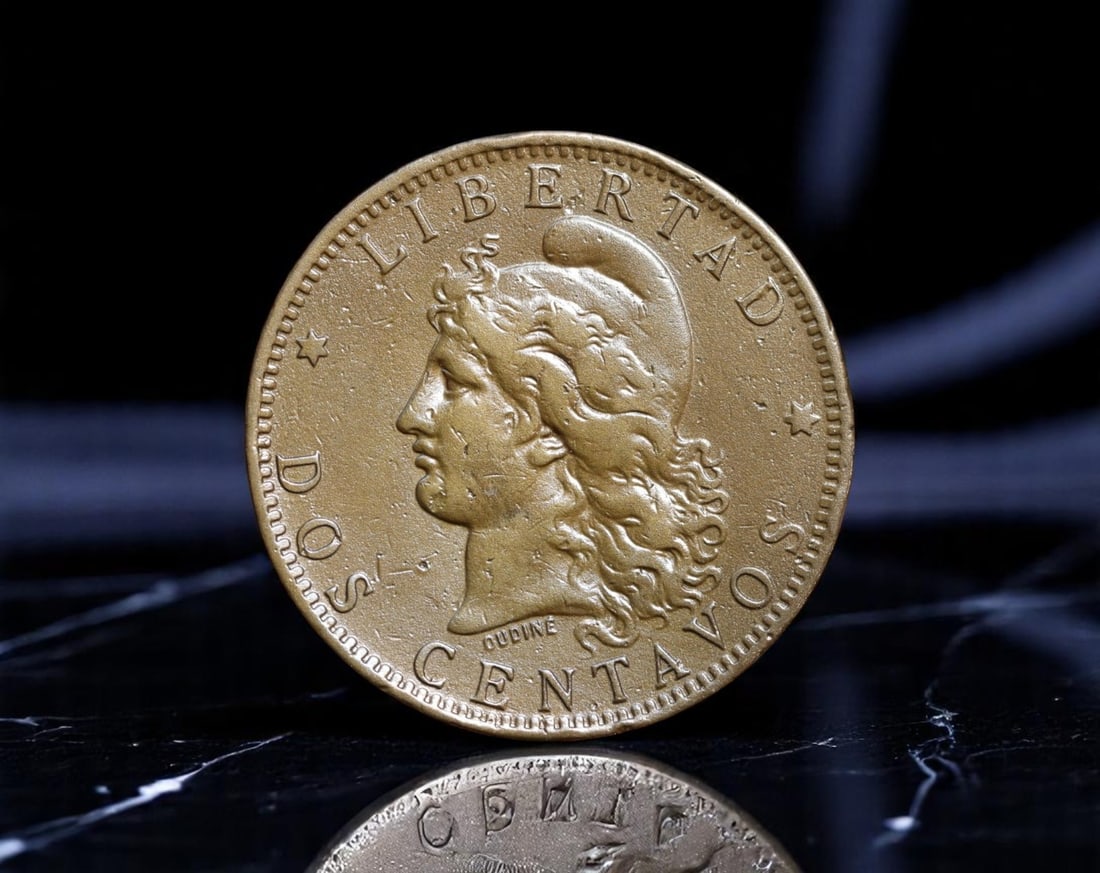 ARGENTINA: Liberty Rising - Dos Centavos Coin, 1885, 30mm: Struck during a pivotal era of national consolidation, the 1885 Dos Centavos coin from Argentina embodies the spirit of newfound unity and republican ideals. The obverse features a striking depiction 