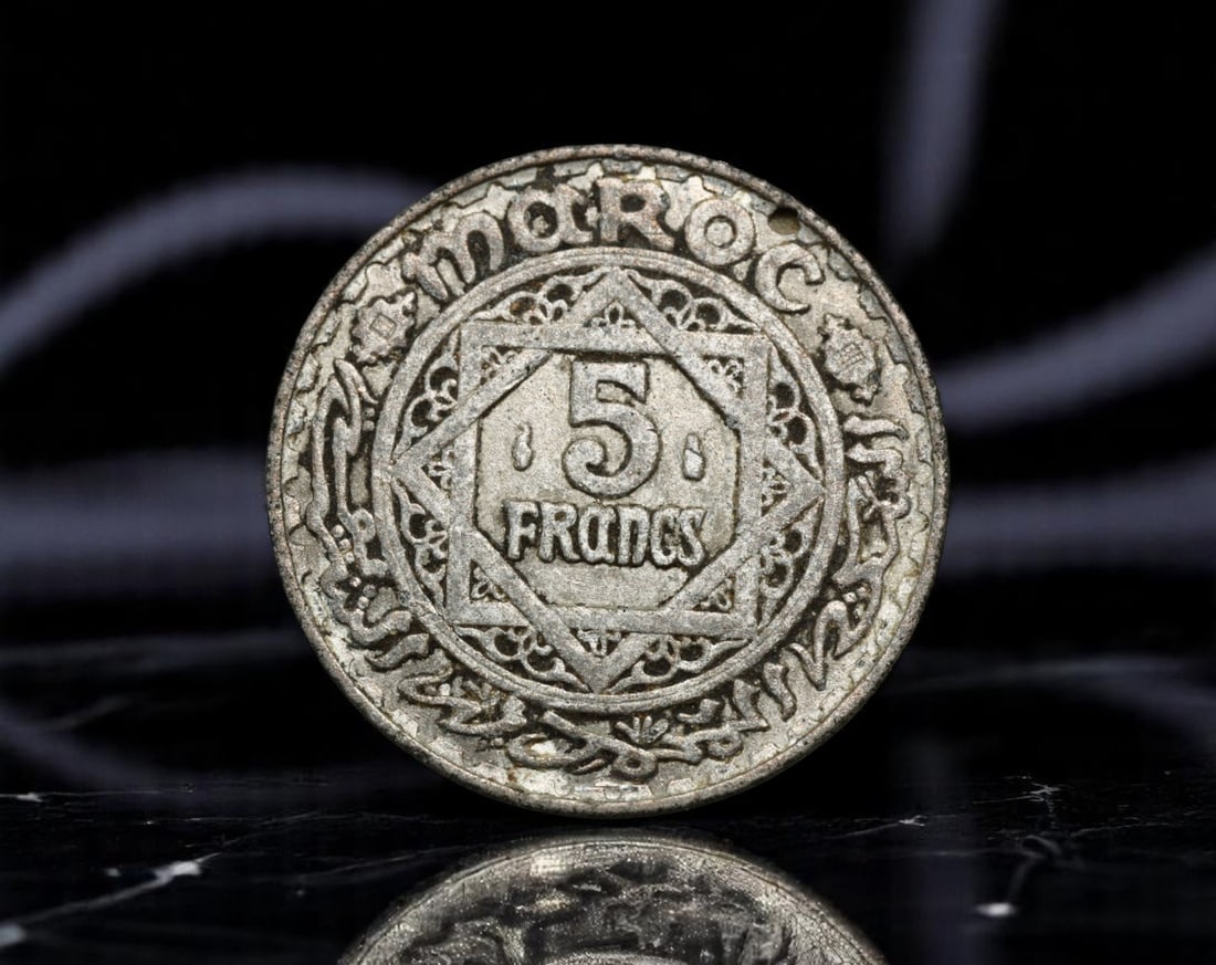 MOROCCO: Empire Cherifien - Islamic Geometry 5 Francs Coin, AH1370 (1951), 25mm: This striking 5 Francs coin from the Cherifian Empire embodies the synthesis of monetary utility and Islamic artistic heritage. Issued in the Hijri year 1370 (equivalent to 1951 CE), the piece feature