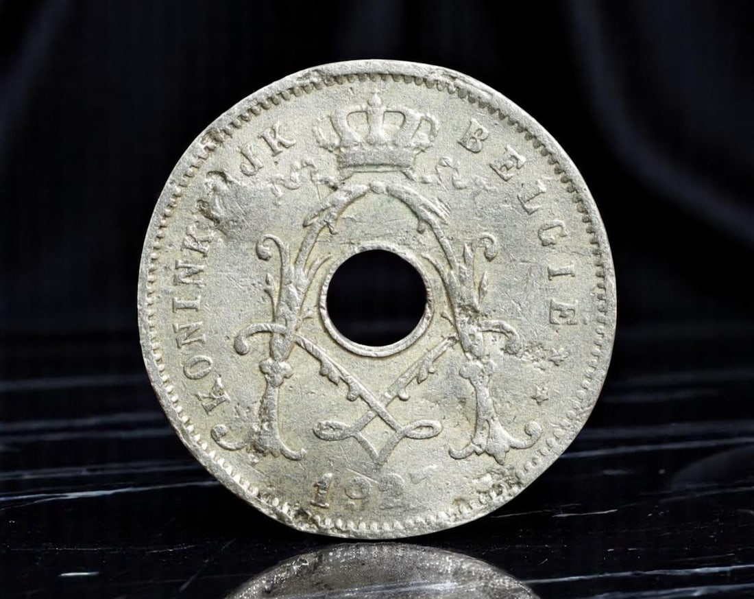 BELGIUM: Royal Insignia - Wartime Emergency 5 Cent Coin, 1917, 19mm: Struck in the throes of World War I, this 1917 Belgian 5 Cent coin is a minimalist yet deeply symbolic product of its era. The central perforation, both practical and stylistic, sets it apart-evoking 
