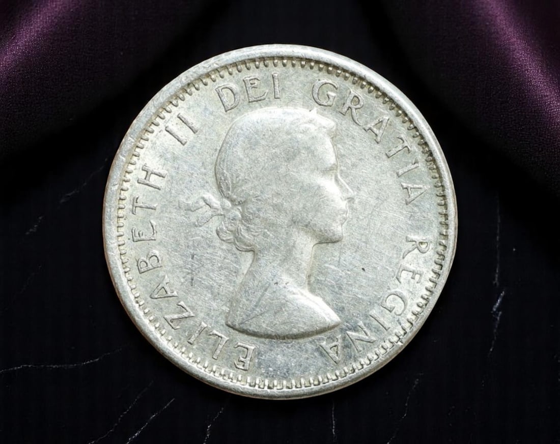 CANADA: Maritime Heritage - Bluenose Schooner 10 Cents Coin, 1963, 18mm: This 1963 Canadian dime showcases the iconic Bluenose schooner, a maritime symbol of speed, resilience, and national pride. With its sails taut against the wind, the vessel reflects Canada's Atlantic