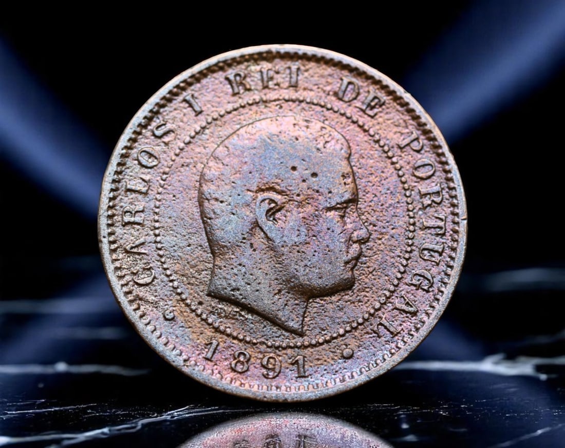 PORTUGAL: King Carlos I - Maritime Expansion 10 Reis Coin, 1891, 25mm: Issued at the dawn of Portugal's final imperial century, this 10 Reis coin under King Carlos I captures the resilience of a monarchy facing both domestic change and colonial ambition. Carlos I's robus