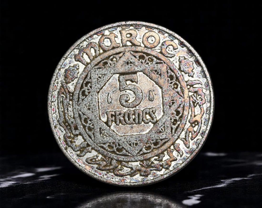 MOROCCO: Sherifian Empire - Moorish Star 5 Francs Coin, 1370 AH (1951 CE), 24mm: Struck during the twilight of French protectorate rule, this 5 Francs coin reflects the elegant fusion of Islamic artistry and colonial-era statecraft under the Sherifian Empire. At its center, an eig