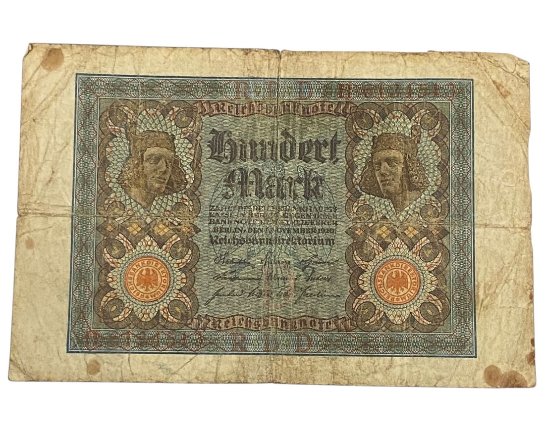 GERMANY/WEIMAR REPUBLIC: Renaissance Legacy - Reichsbanknote 100 Mark Banknote, 1920 Berlin, 16x11cm: This 1920 Reichsbanknote for 100 Marks exemplifies the Weimar Republic's reliance on established imperial motifs to navigate a period of transition and monetary fragility. Twin male busts in Renaissan
