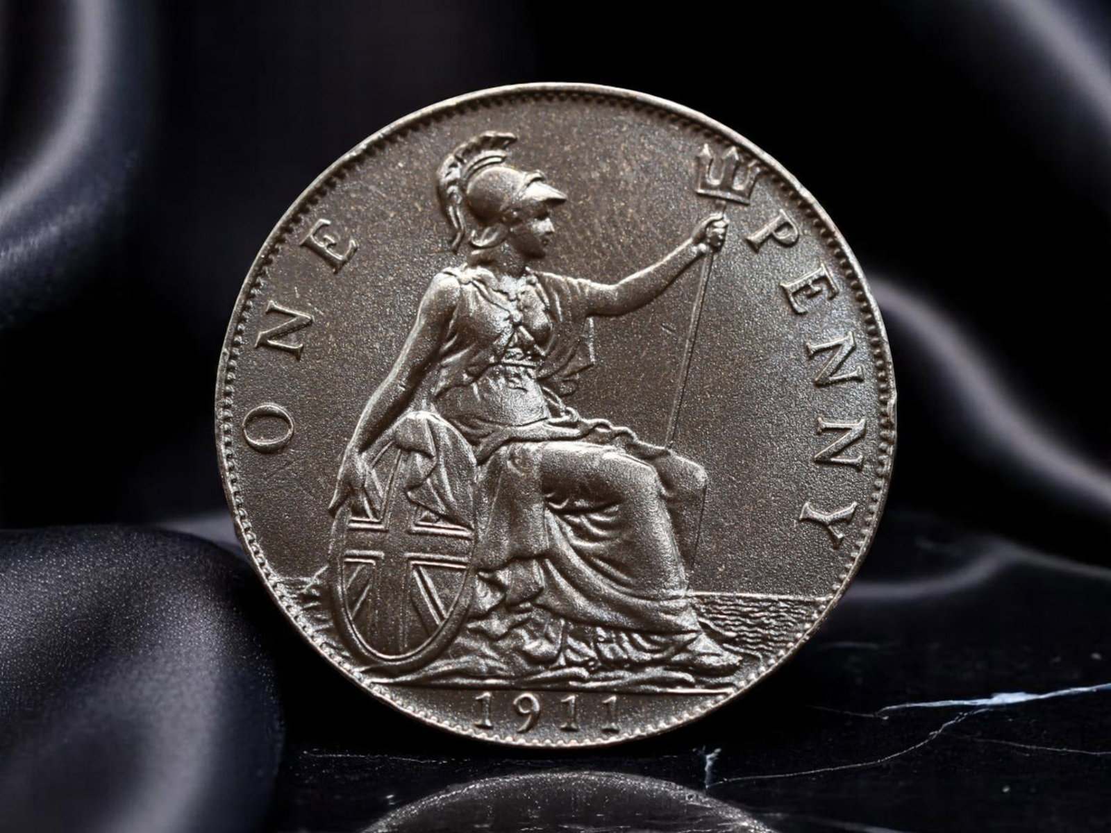 GREAT BRITAIN: King George V - Imperial Strength One Penny Coin, 1911, 31mm: Issued in the inaugural year of King George V's reign, this 1911 One Penny embodies the enduring ideals of empire and national unity. The obverse captures the resolute profile of the newly crowned mon
