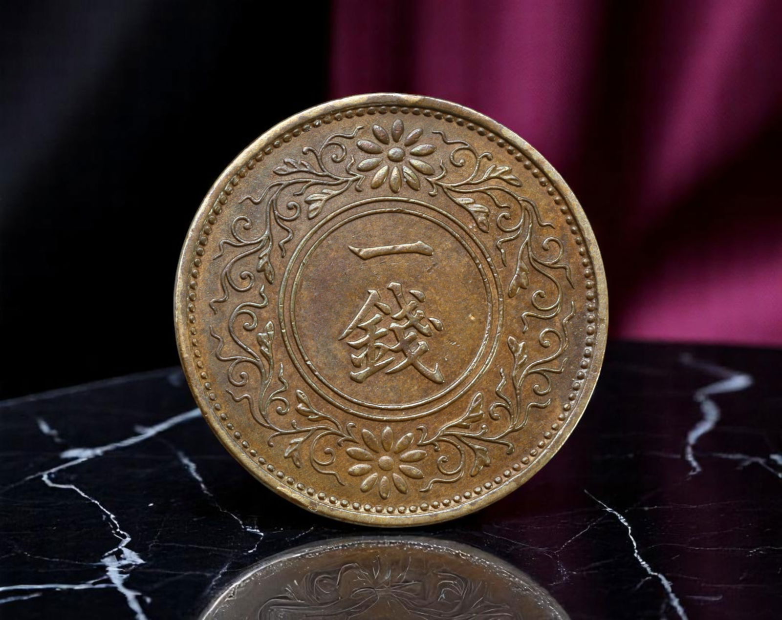 JAPAN/EMPIRE: Showa Sovereignty - 1 Sen Coin, Showa Year 10 (1935), 23mm: Issued in 1935 during Emperor Hirohito's reign, this 1 Sen coin embodies the disciplined elegance of Japan's imperial numismatic artistry. The obverse features a bold paulownia crest, the emblem of th