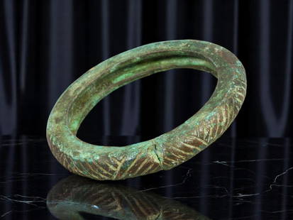 EARLY MEDIEVAL Cast Bronze Bracelet - Deeply Incised Chevron Pattern, 6.2 cm: An impressively solid bronze bangle with a sculptural presence, this early medieval bracelet features a cast form enriched by deeply carved chevron and V-motifs in rhythmic succession. Its time-soften
