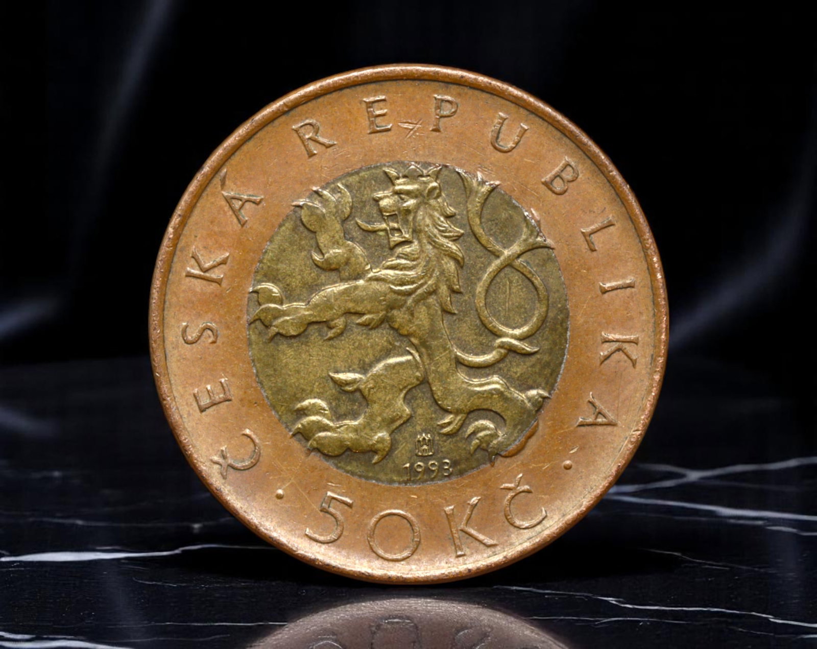 CZECH REPUBLIC: Praga Mater Urbium - 50 Korun Coin, 1993, 27mm: Struck in 1993 during the inaugural year of the Czech Republic's monetary sovereignty, this bimetallic 50 Korun coin unites the national heraldic lion with the architectural majesty of Prague. The obv