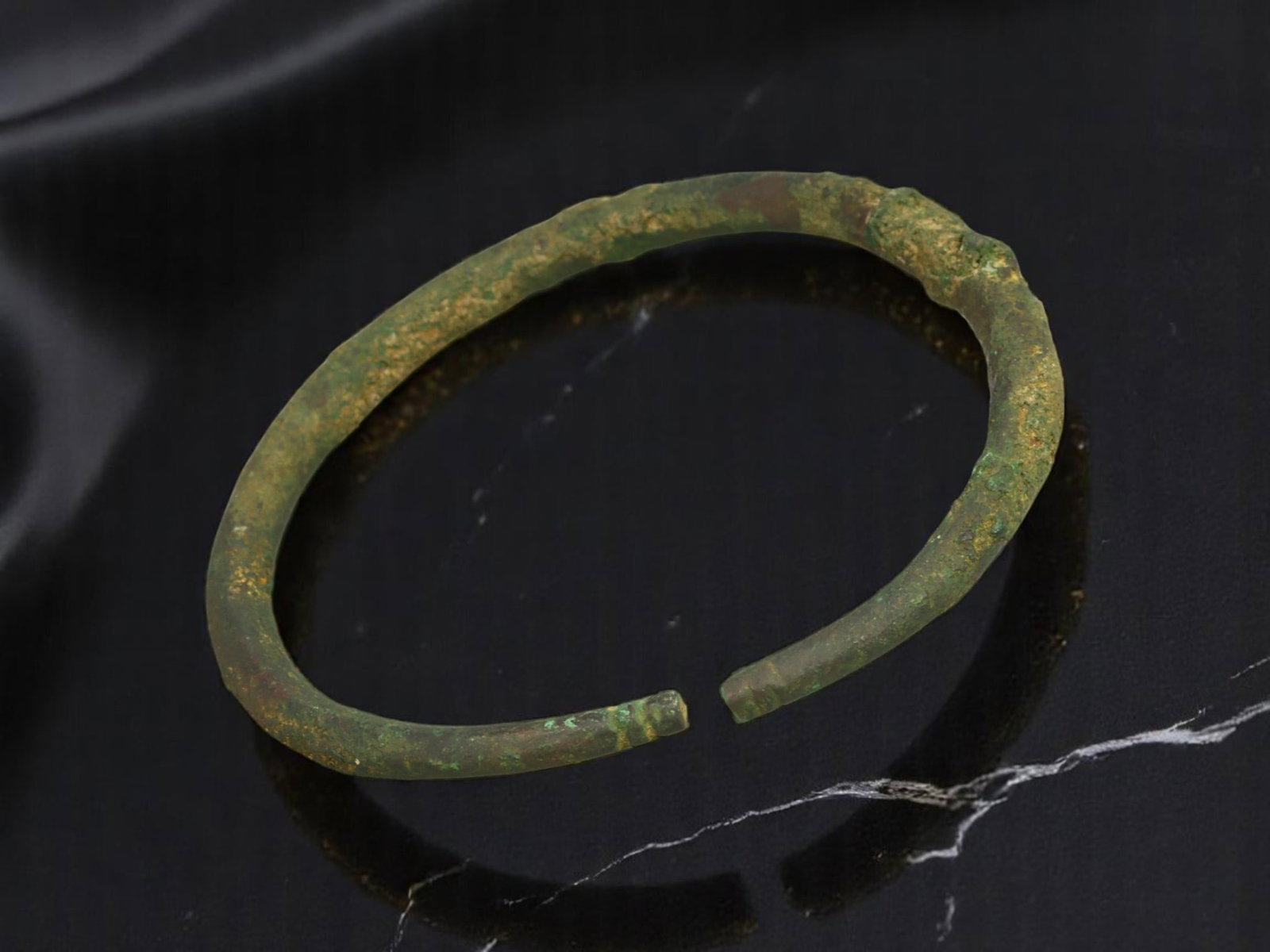 CELTIC Bronze Bracelet - Irregular Forged Band, Open-Ended Form, 6.2 cm: A rugged example of early Celtic adornment, this open-ended bracelet is crafted from bronze with a lightly tapering, organically formed band. The surface bears deep green and russet patina, with evide