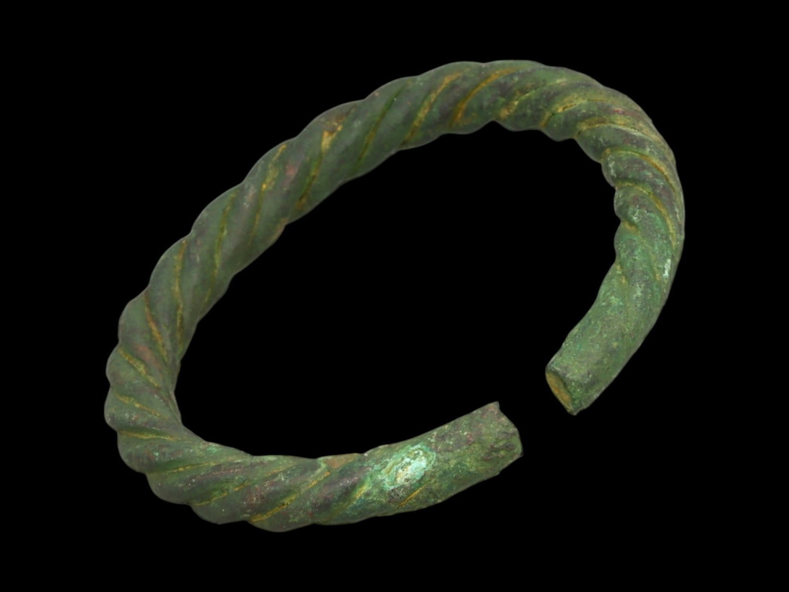 PROTO-CELTIC Bronze Bracelet - Early Spiral-Bar Segment with Seam Join, Closed Circle (5.2 cm): A rare early form, this compact proto-Celtic bracelet features a partially spiral-bar design with a visible transition into a smoothed terminal segment-joined in a tight closed-loop format. The sharpl