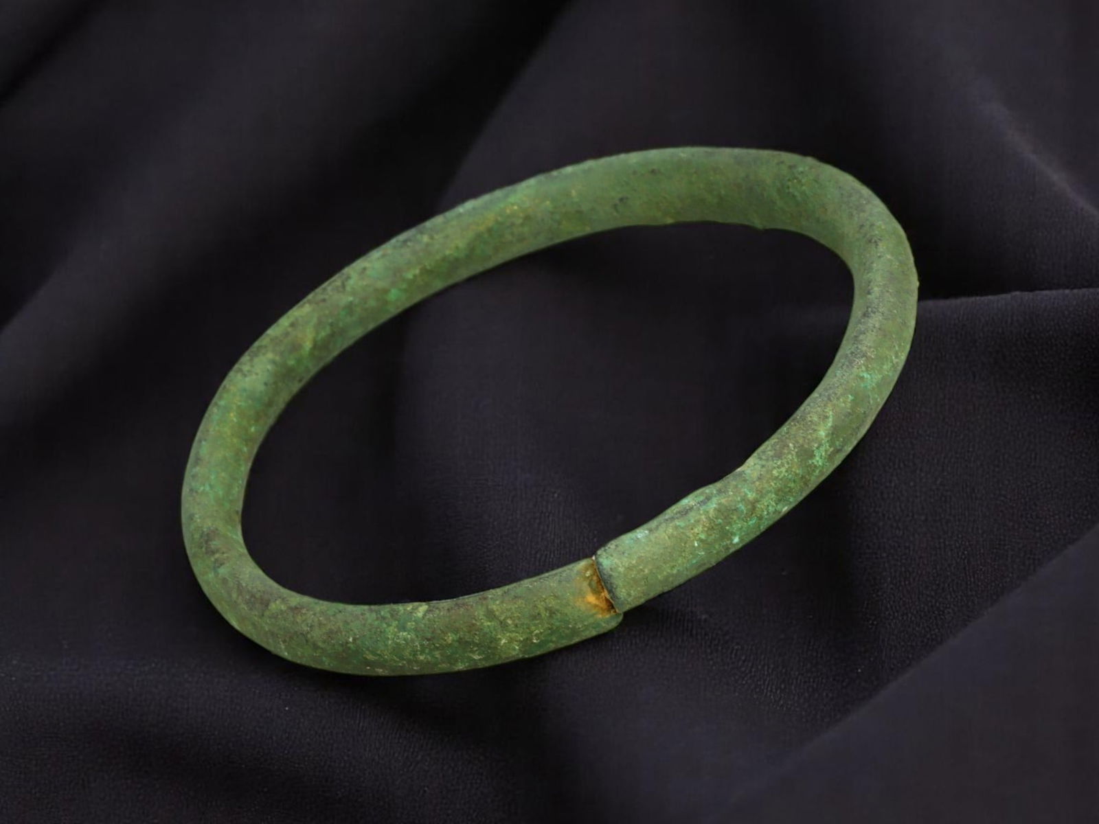 CELTIC Bronze Bracelet - Compact Round Band with Seam-Fit Terminals (5.3 cm): This compact Celtic bracelet features a solid, round-profile band with a near-seamless terminal join, forming a tight, wrist-hugging circle. The surface retains a granular texture beneath layers of st