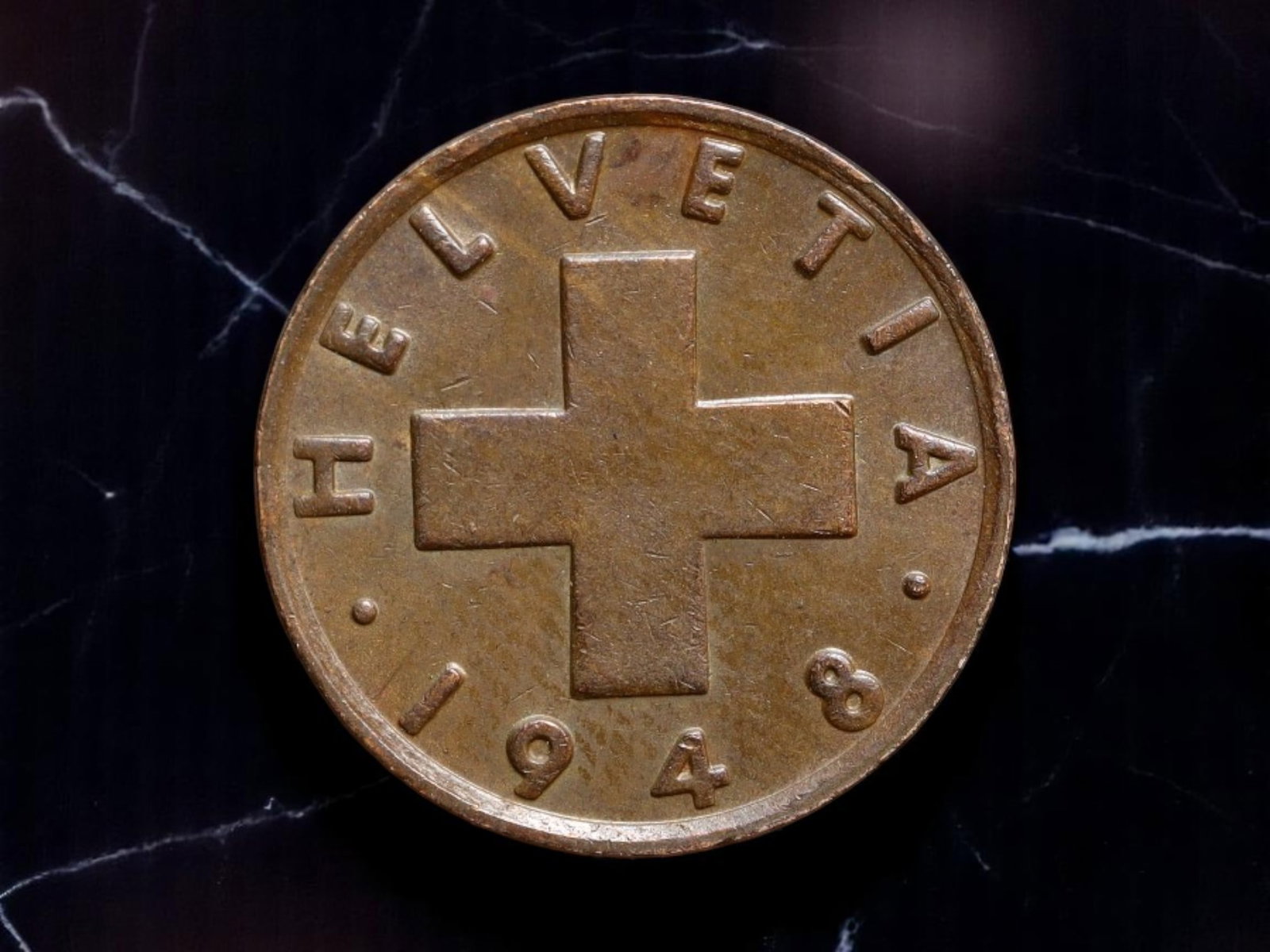 SWITZERLAND: Agricultural Renewal - Helvetia 2 Rappen Coin, 1948 B, 20mm: Issued in the fragile postwar years, this 1948 Swiss 2 Rappen coin speaks to national self-reliance through the clear symbolism of labor and land. One side bears the bold Helvetic cross framed by the 