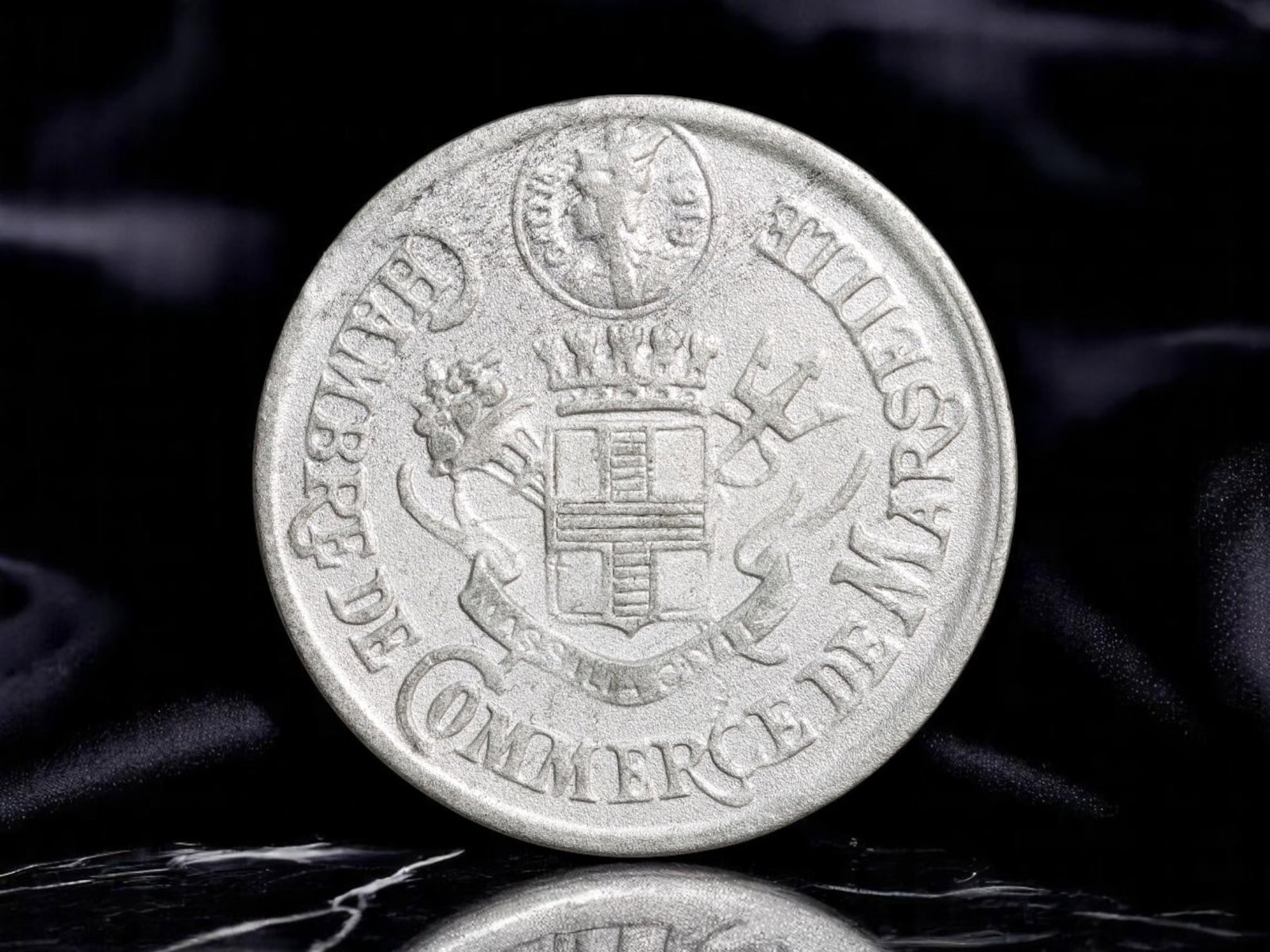 FRANCE: Wartime Necessity - Marseille Chamber of Commerce 10 Centimes Coin, 1916, 28mm: Issued in 1916 amidst the turmoil of World War I, this emergency 10 Centimes coin from the Chamber of Commerce of Marseille reflects the practical ingenuity of France's home front economy. The obverse
