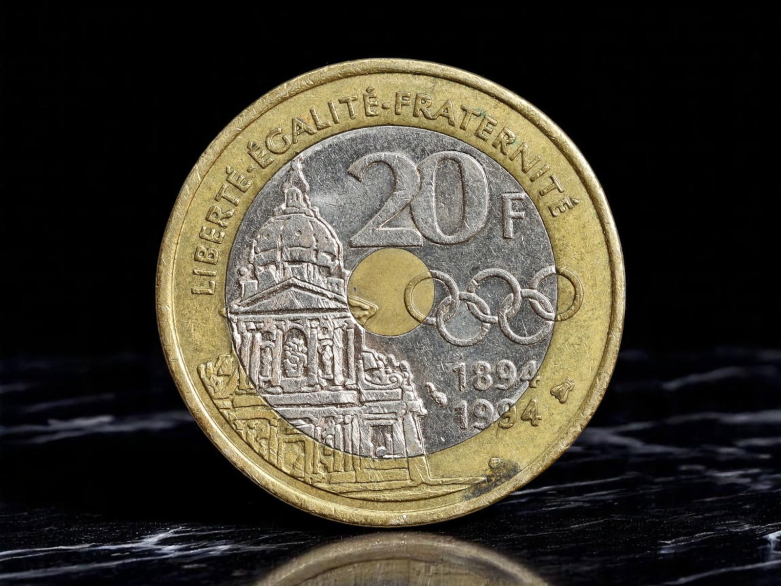 FRANCE: Olympic Renaissance - Pierre de Coubertin 20 Francs Coin, 1994, 26mm: Issued in 1994 to mark the centennial of the modern Olympic Games, this 20 Francs coin pays tribute to Pierre de Coubertin, the visionary French nobleman whose ideals redefined international sport. Hi