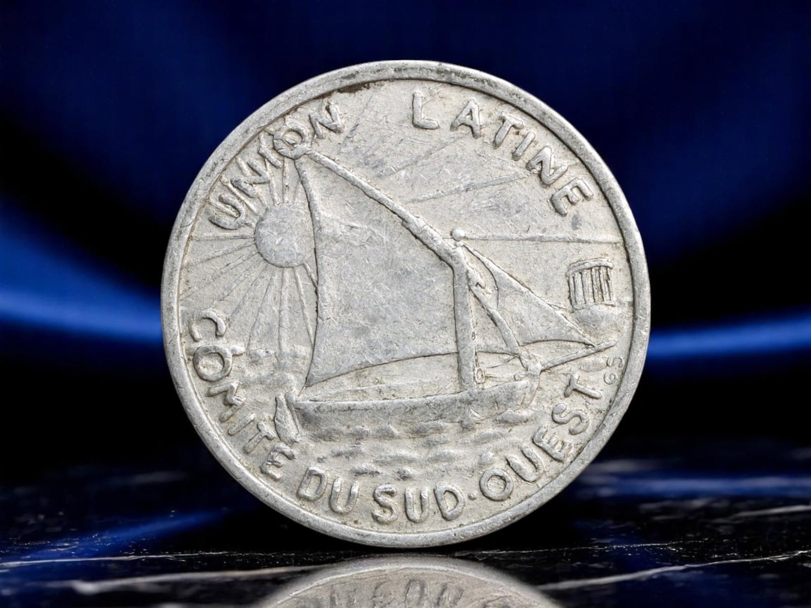 FRANCE: Latin Union Solidarity - Haute-Garonne Emergency 10 Centimes Token, 1922-1927, 23mm: Struck amid the interwar recovery period, this 10 Centimes aluminum token issued in Toulouse reflects both regional pride and broader Latin cultural solidarity. One side bears the radiant image of a s