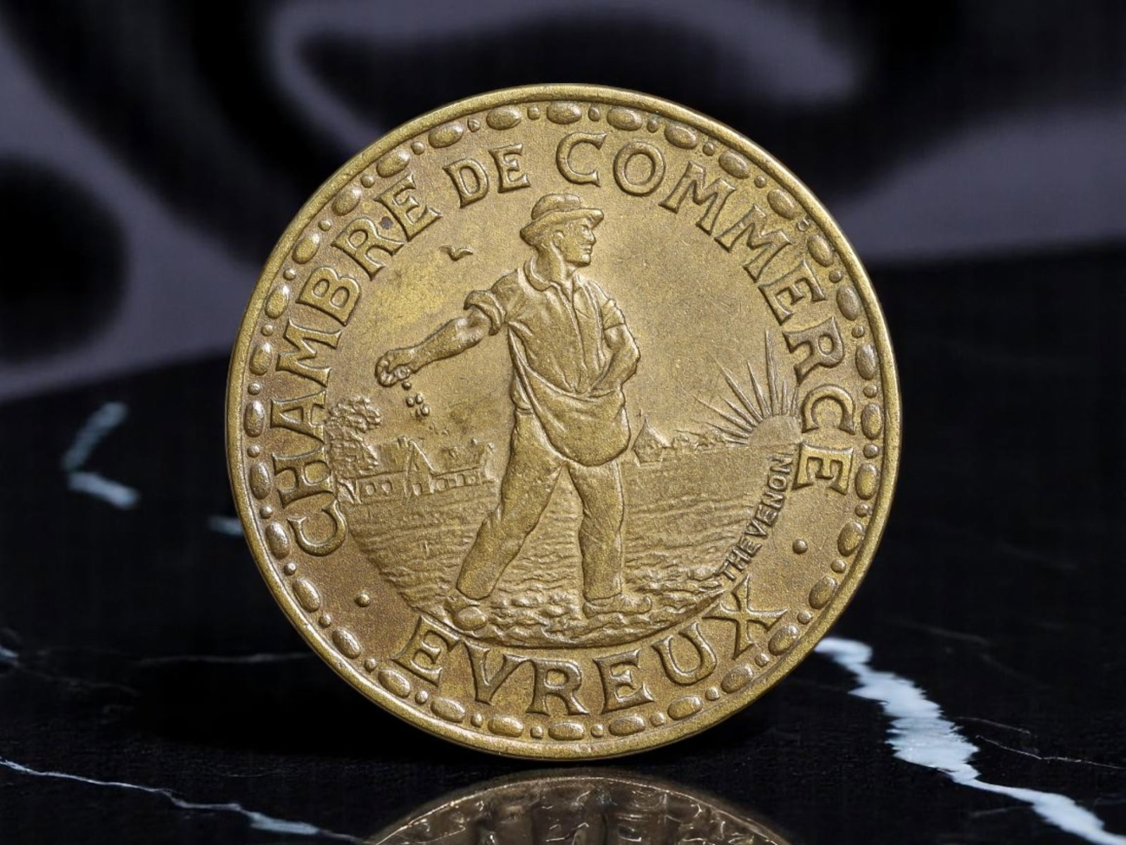 FRANCE: Postwar Renewal - Chamber of Commerce 1 Franc Coin, 1922 Evreux, 24mm: Issued by the local Chamber of Commerce during France's economic realignment after World War I, this 1922 Evreux 1 Franc coin presents a poignant image of national recovery through labor. The obverse 