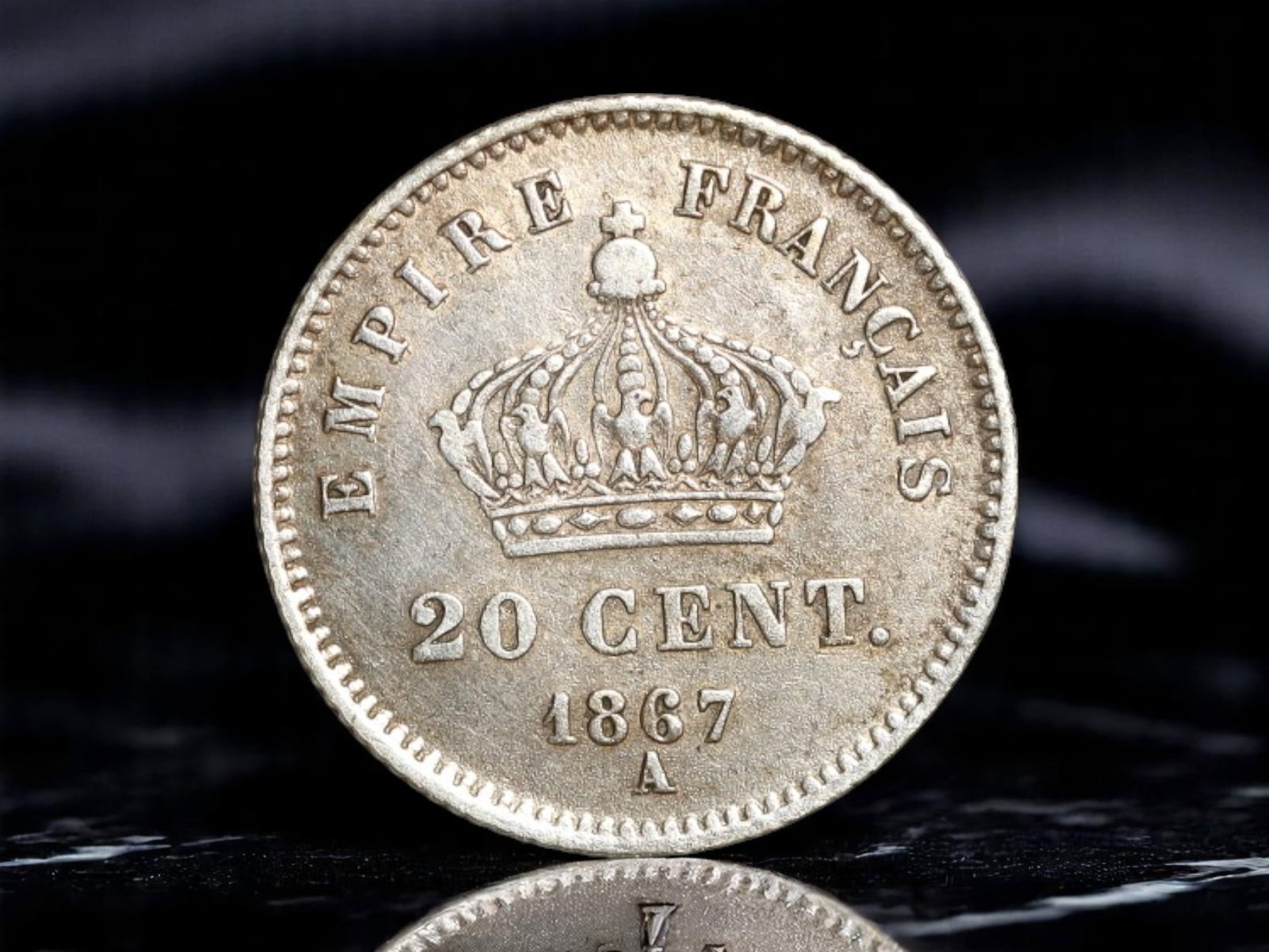 FRANCE: Napoleon III - Imperial Authority Silver 20 Centimes Coin, 1867 A Paris Mint, 15mm: This silver 20 Centimes coin, struck in 1867 at the Paris Mint, embodies the grandeur and monarchical assertion of the Second French Empire under Napoleon III. The obverse presents a finely detailed l