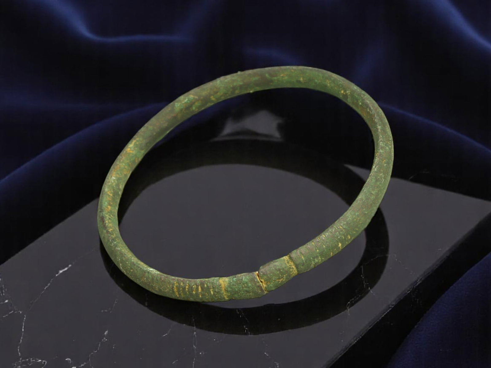 ROMAN Bronze Bracelet - Narrow Rod Band with Incised Terminal Rings and Seam Join (5.7 cm): This Roman bracelet features a delicately tapered rod band, seamlessly joined in a full circular form. The terminals are detailed with fine concentric incisions-likely symbolic or workshop signatures.