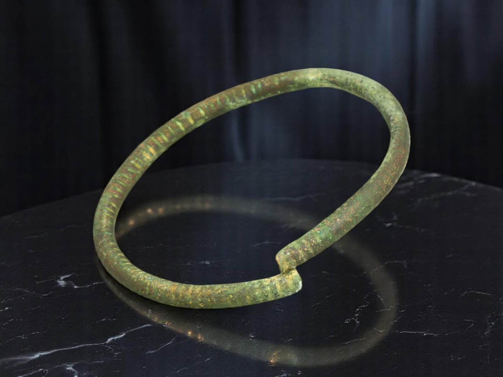 ROMAN Bronze Bracelet - Light Rod Form with Continuous Line Engraving, Open-Ended (5.3 cm): This Roman-era bracelet is crafted from a slim, evenly rounded rod, subtly tapered at the open terminals. Its defining feature is a continuous, closely spaced linear engraving that encircles the full 