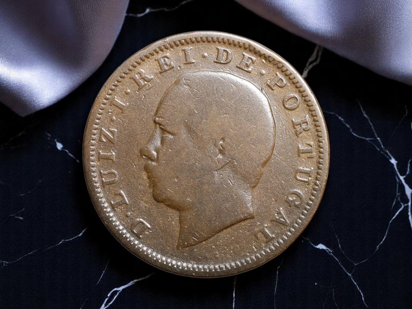 PORTUGAL: Luiz I - Naval Ambition 20 Reis Coin, 1883, 30mm: Struck during the reign of Dom Luiz I, known as the "Sailor King," this 1883 20 Reis coin captures a monarch who sought to steer Portugal through maritime modernization and colonial expansion. The lef