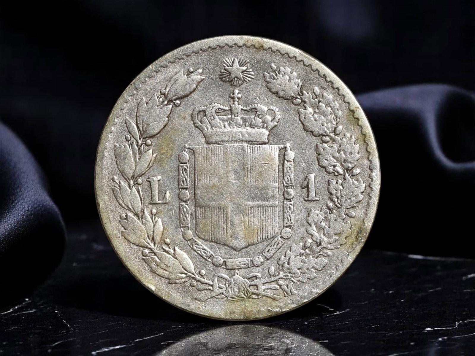 ITALY: Umberto I - Royal Arms Unity Silver 1 Lira Coin, 1887, 24mm: This 1887 silver 1 Lira coin issued under King Umberto I of Italy embodies the spirit of national consolidation during a transformative chapter in the kingdom's history. The obverse bears a crisply de