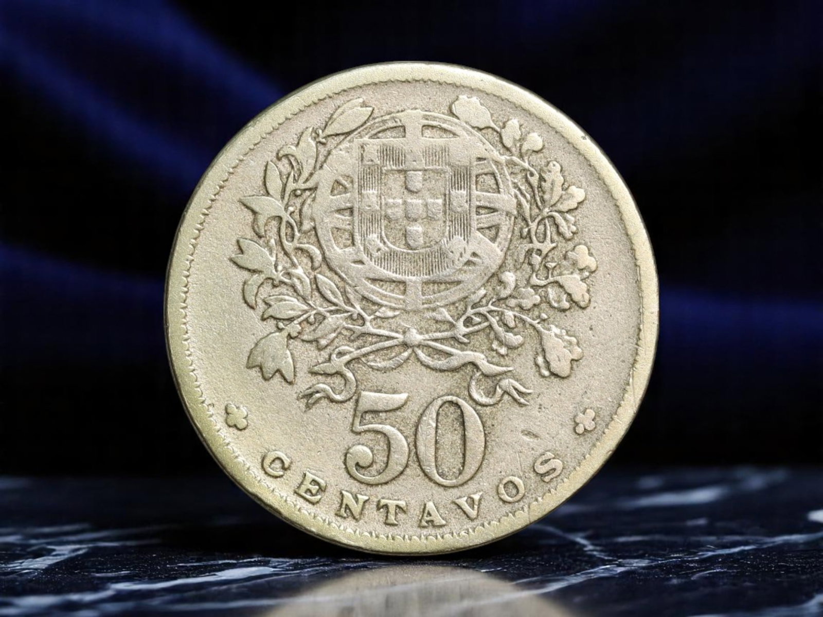 PORTUGAL: National Renaissance - Liberty Allegory 50 Centavos Coin, 1935, 22mm: Issued during the formative years of the Estado Novo regime, this 1935 50 Centavos coin merges classical aesthetics with the ideological rebirth of the Portuguese Republic. The obverse portrays the bu