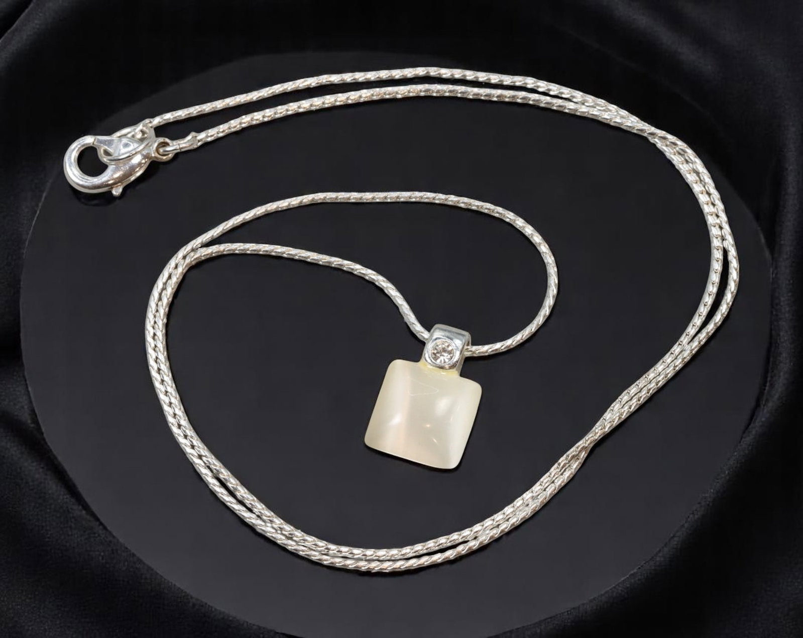 ARTISTIC MODERN STYLE: Necklace - Frosted Cube Pendant with Clear Accent on Silvertone Chain (46 cm): Minimalist and luminous, this artistic modern necklace features a softly frosted cube-like pendant accented with a brilliant clear stone at the bail. Suspended from a sleek silvertone woven chain, the