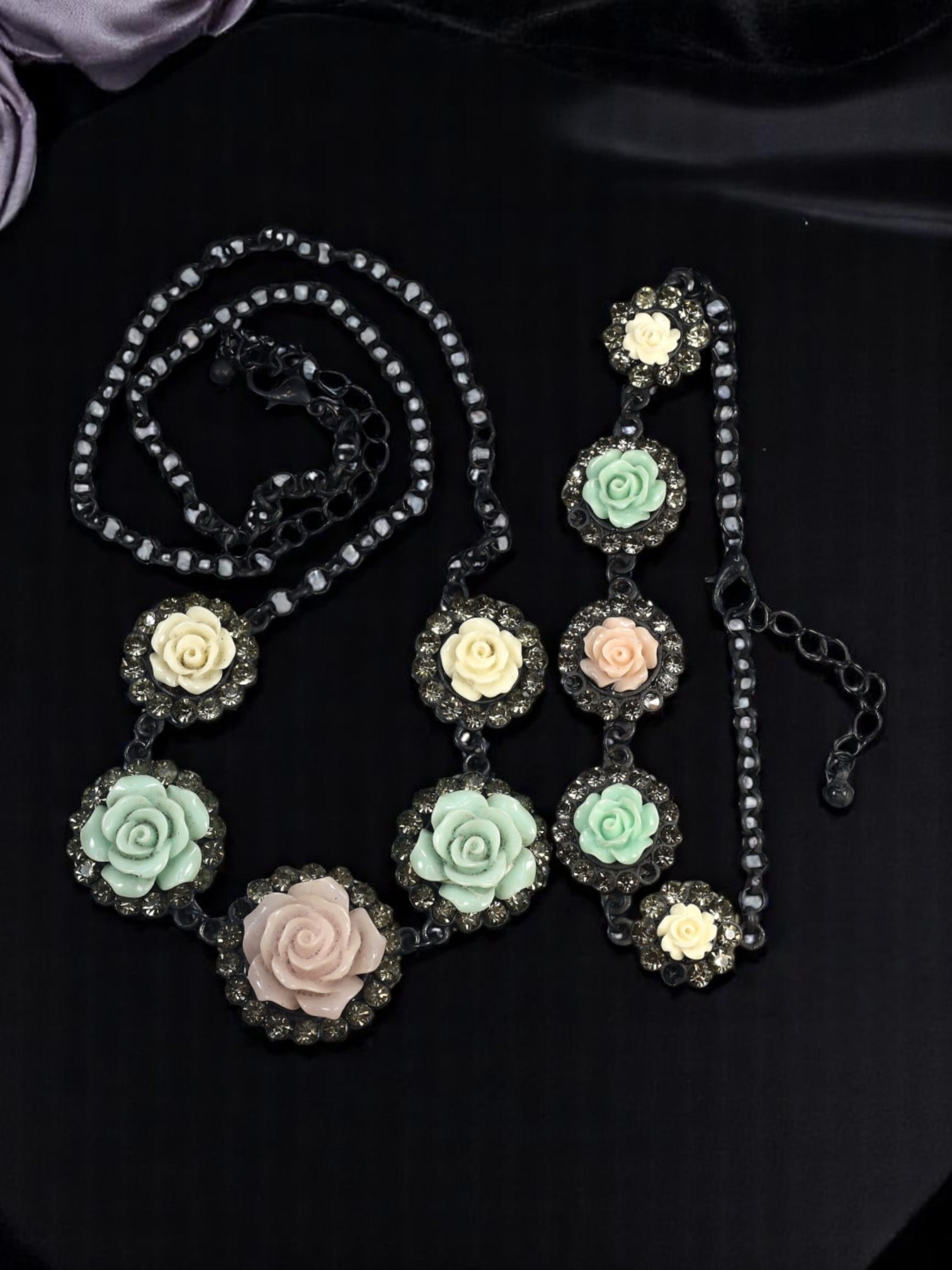 Necklace & Bracelet Set - Pastel Floral Motifs, Black Metal Frames 24cm, 51cm: From an estate jewelry collection, this enchanting set exemplifies the soft yet bold aesthetic of modern romantic design. The necklace and matching bracelet feature intricately molded rose-like floral