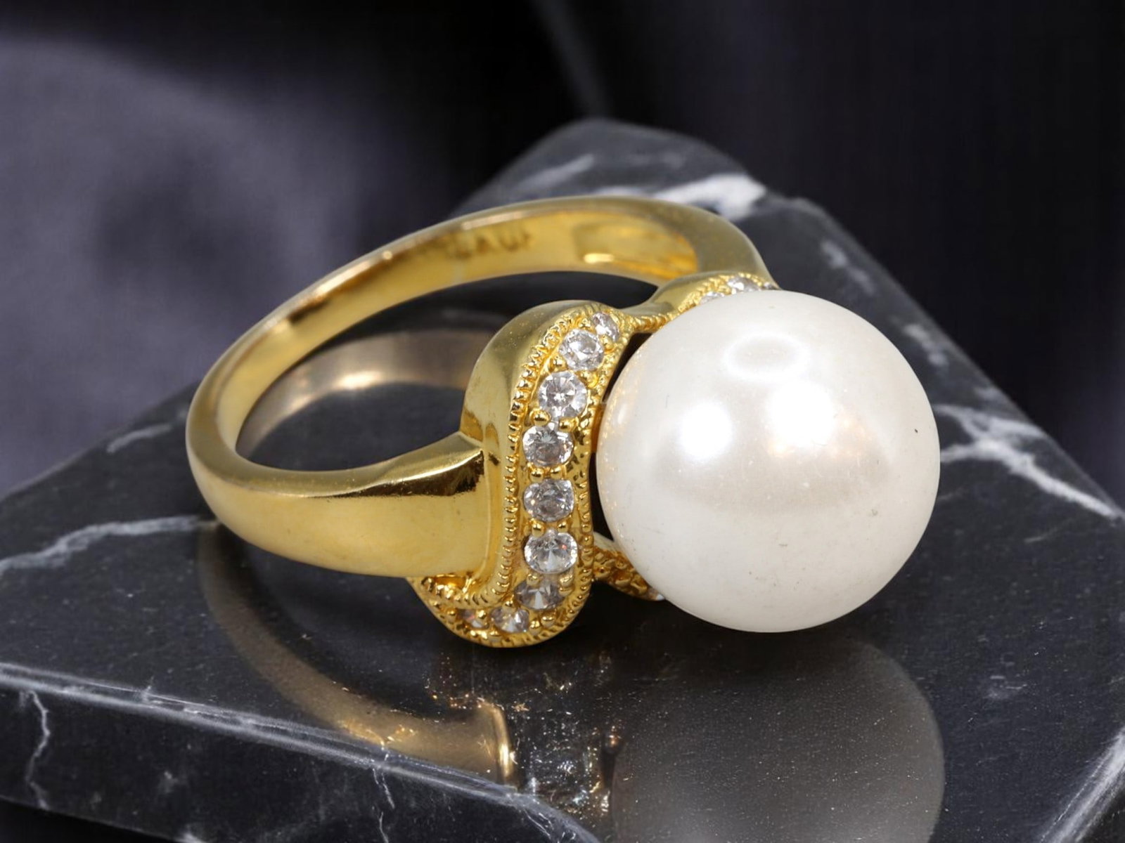 HOLLYWOOD ERA: Statement Ring - Sculptural Pearl-Like Dome with Clear Accent Stones, Size 8 US: An iconic example of Retro Modern glamour, this bold statement ring showcases a luminous pearl-like dome at center, encircled by a sweeping sculptural goldtone band set with brilliant-cut clear accent