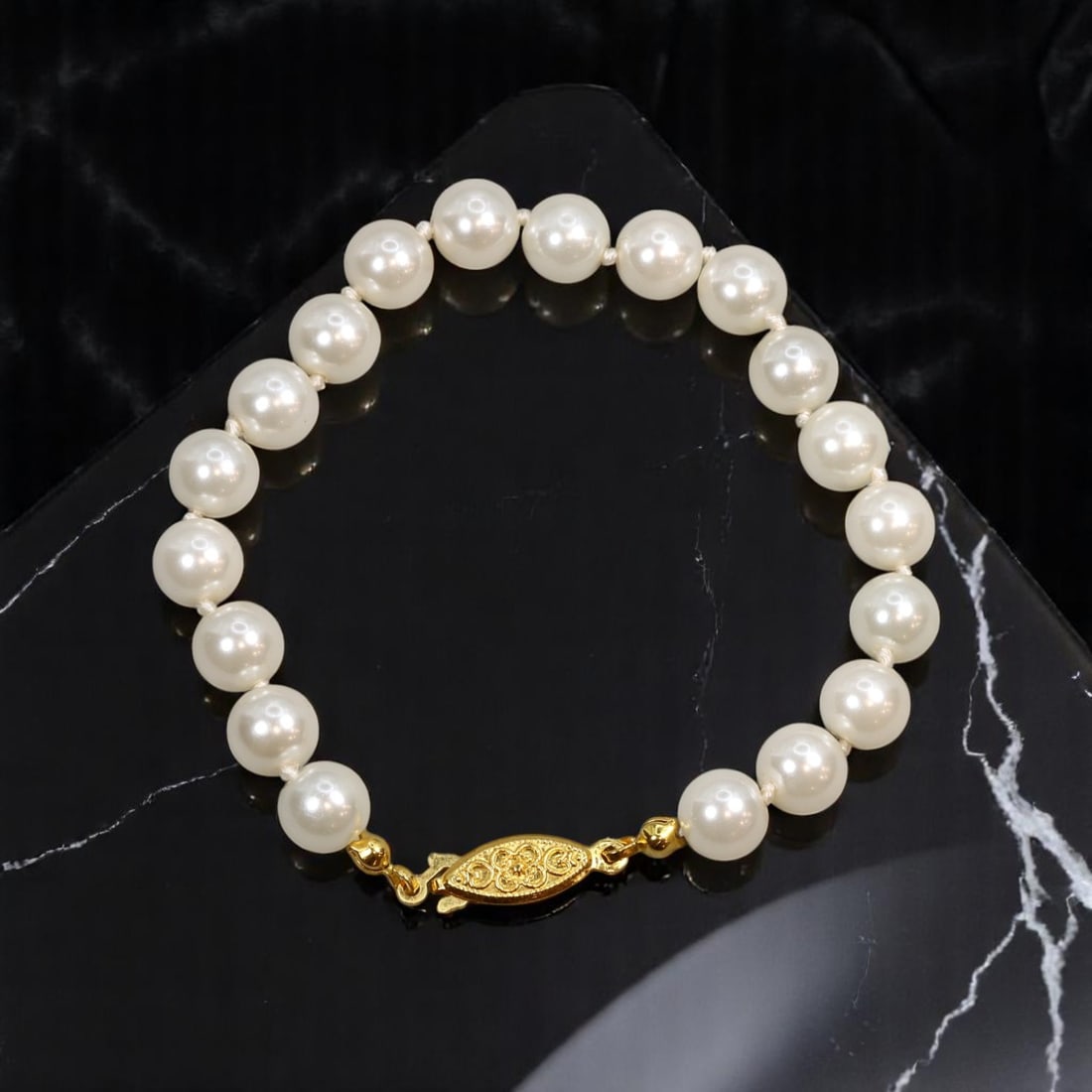 VINTAGE MID-CENTURY: Bracelet - Pearl-Like Beads, Goldtone Filigree Clasp (18 cm): A classic mid-century bracelet exuding understated elegance, this single strand design features luminous pearl-like beads strung to an approximate length of 18 cm. The bracelet is beautifully finished
