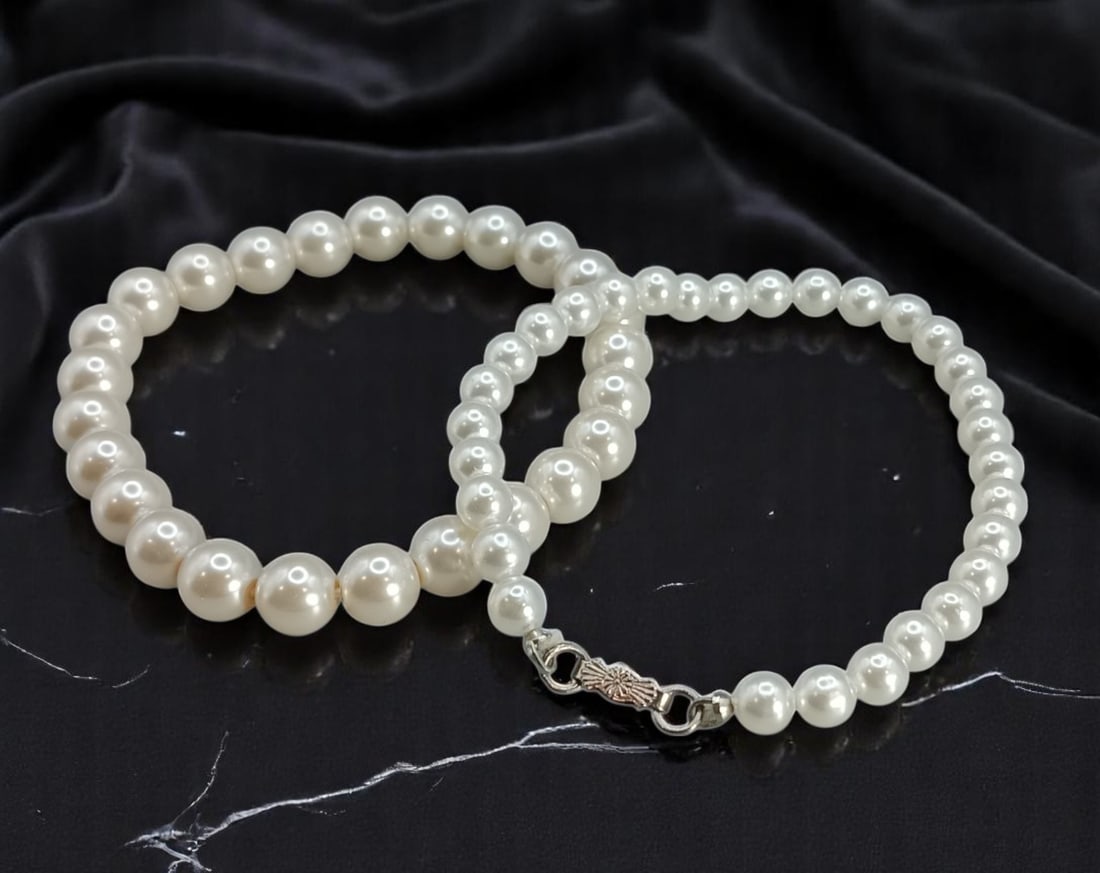 Bracelet Pair - Pearl-Like Beads, Classic Single Strand Styles: This elegant pair of vintage bracelets captures the timeless charm of mid-century styling, each featuring luminous pearl-like beads in classic single strand designs. One bracelet is strung with bold, 