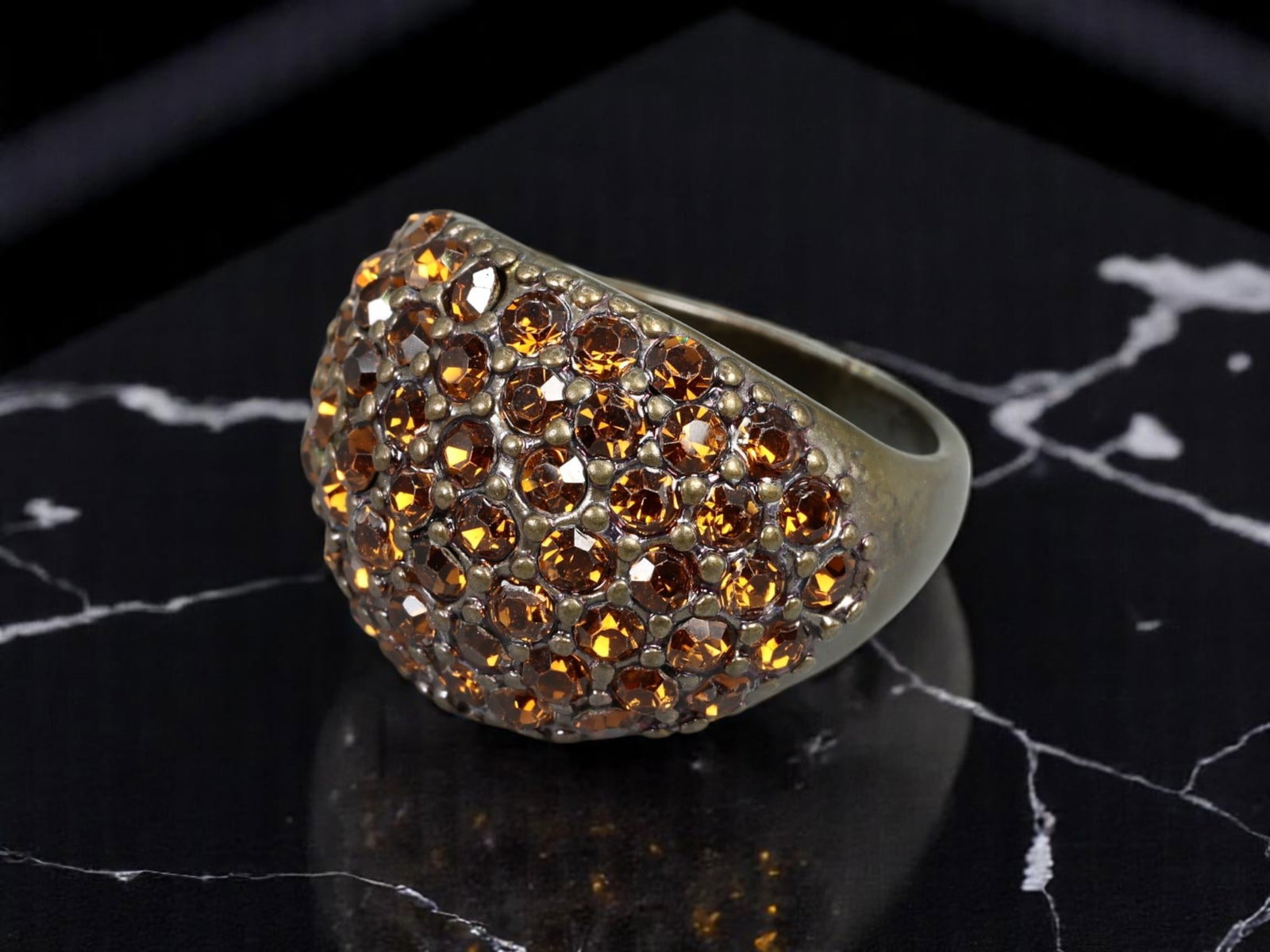 Domed Cocktail Ring - Goldtone with Amber-Like Pave Stones, US 7: A bold and glamorous domed cocktail ring, this Retro Modern design showcases a dense pave setting of vibrant amber-like faceted stones across a warm goldtone backdrop. The high dome silhouette and clu