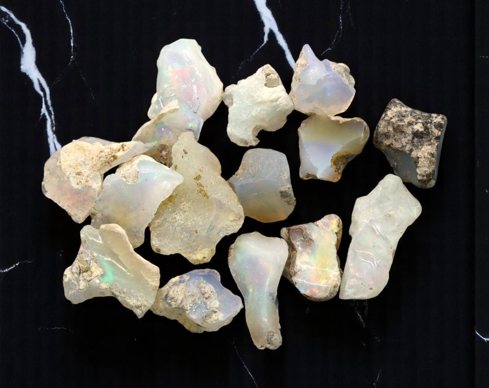 GEM LOT: Ethiopian Welo Opal Rough - Iridescent Play-of-Color in Matrix, Mixed Forms (6g): An estate-sourced parcel of natural Ethiopian Welo Opal rough, this lot features raw, matrix-hosted specimens with vibrant play-of-color across milky, translucent, and honey-toned bodies. Flashes of g
