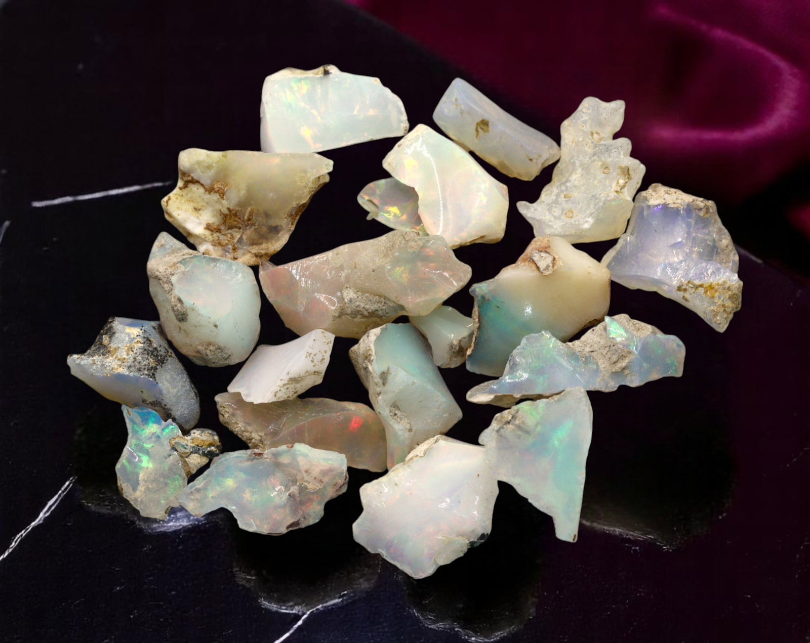 GEM LOT: Ethiopian Welo Opal Rough - Iridescent Play-of-Color in Matrix, Mixed Forms (7g): An estate-sourced parcel of natural Ethiopian Welo Opal rough, this lot features raw, matrix-hosted specimens with vibrant play-of-color across milky, translucent, and honey-toned bodies. Flashes of g