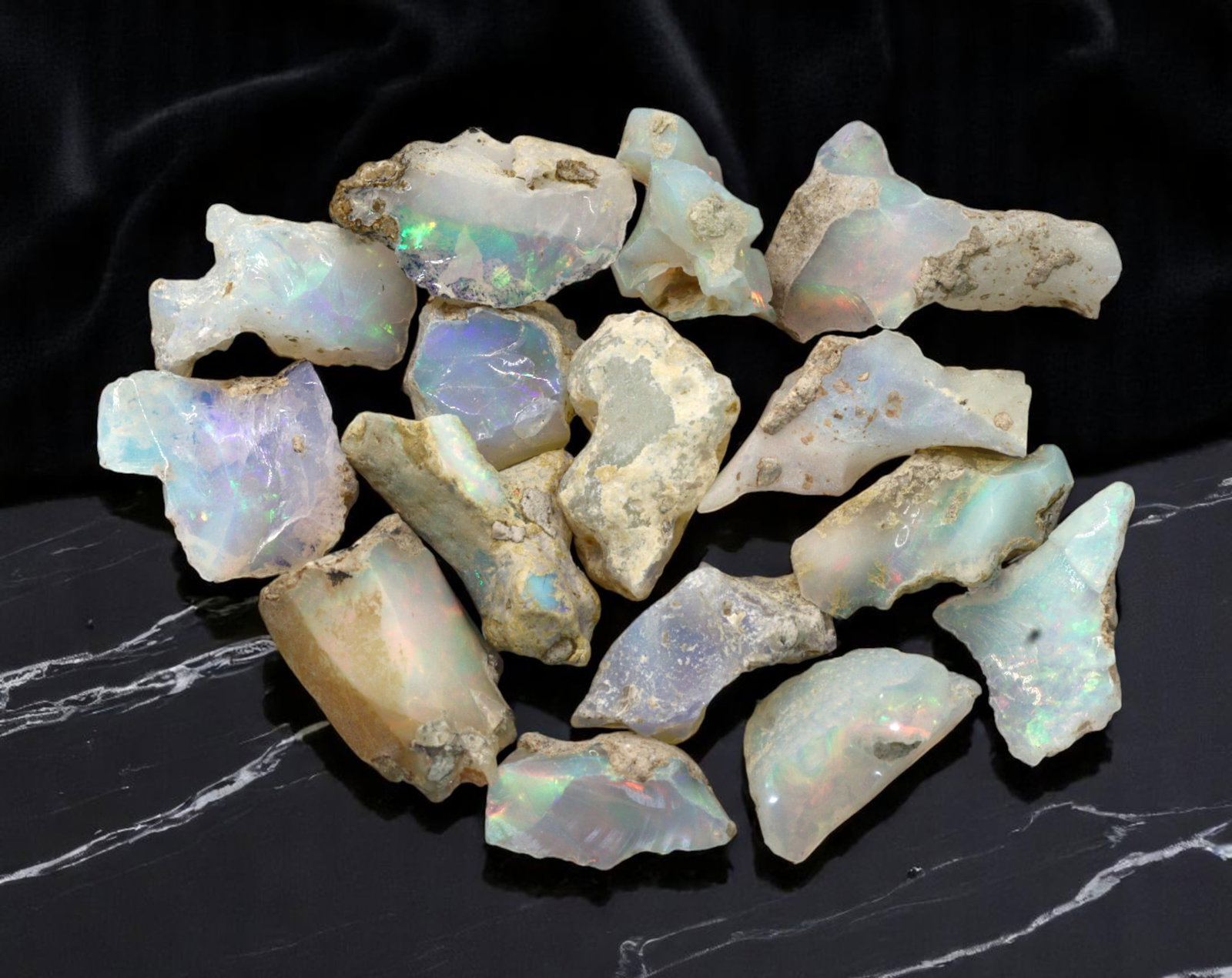 GEM LOT: Ethiopian Welo Opal Rough - Iridescent Play-of-Color in Matrix, Mixed Forms (7g): An estate-sourced parcel of natural Ethiopian Welo Opal rough, this lot features raw, matrix-hosted specimens with vibrant play-of-color across milky, translucent, and honey-toned bodies. Flashes of g
