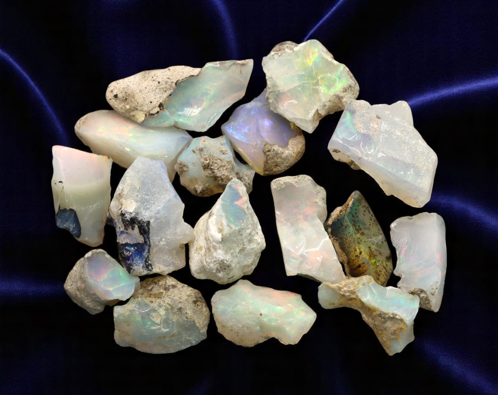 GEM LOT: Ethiopian Welo Opal Rough - Iridescent Play-of-Color in Matrix, Mixed Forms (8g): An estate-sourced parcel of natural Ethiopian Welo Opal rough, this lot features raw, matrix-hosted specimens with vibrant play-of-color across milky, translucent, and honey-toned bodies. Flashes of g