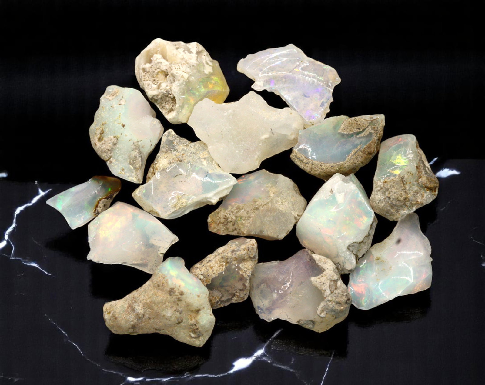GEM LOT: Ethiopian Welo Opal Rough - Iridescent Play-of-Color in Matrix, Mixed Forms (8g): An estate-sourced parcel of natural Ethiopian Welo Opal rough, this lot features raw, matrix-hosted specimens with vibrant play-of-color across milky, translucent, and honey-toned bodies. Flashes of g