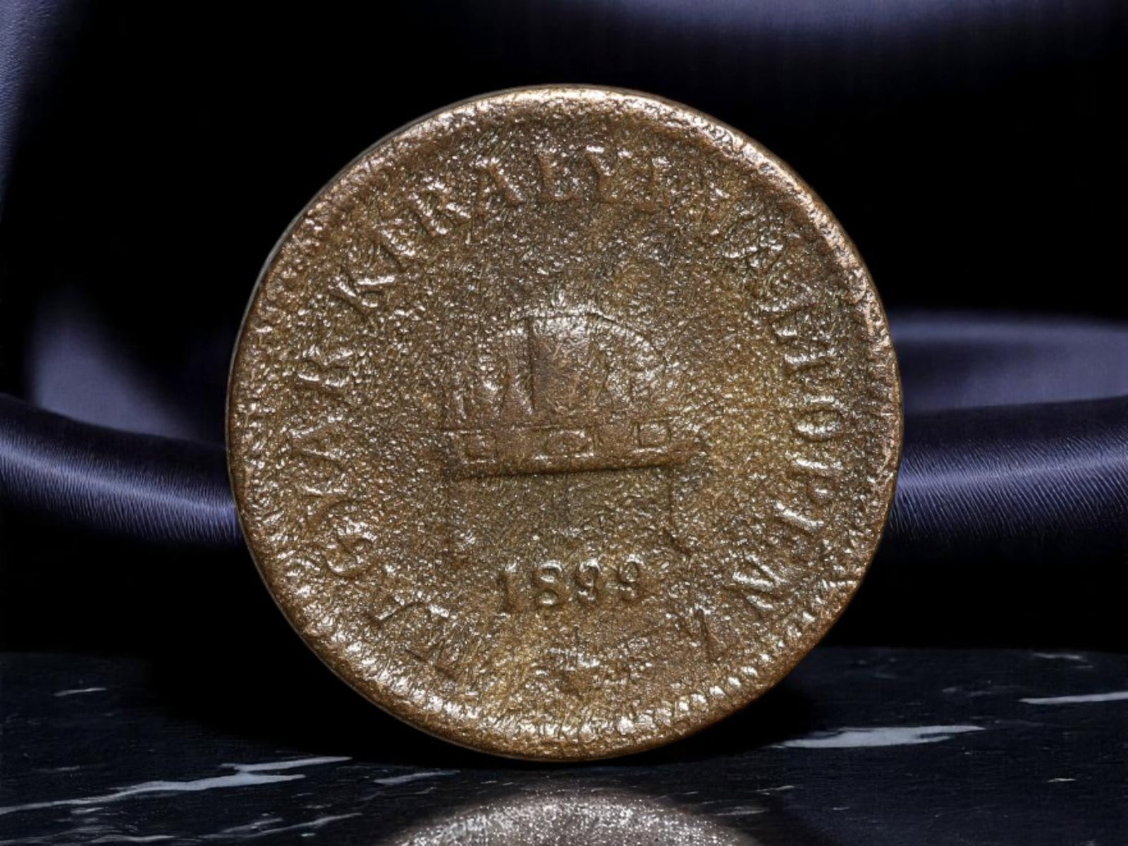 HUNGARY: Franz Joseph I - Millennial Era 2 Filler Coin, 1899, 19mm: Minted at the twilight of the 19th century, this bronze 2 Filler piece embodies the economic confidence of Hungary under the Dual Monarchy. The obverse prominently displays the Holy Crown of Hungary a