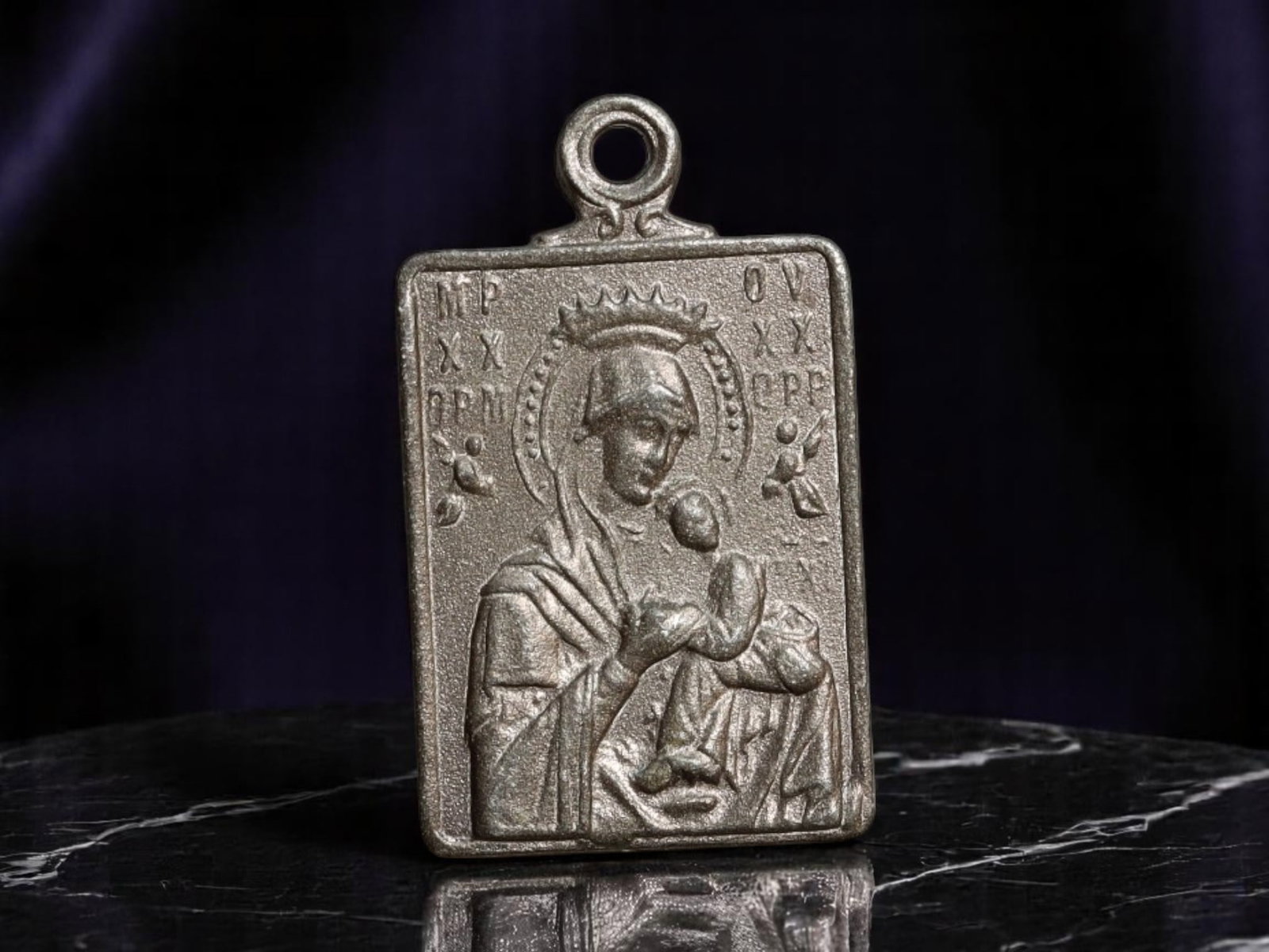 EASTERN EUROPE: Orthodox Devotion - Byzantine Icon of Theotokos and Christ, 20mm: Rooted in the iconographic traditions of Eastern Christianity, this 20mm devotional medal honors the Theotokos (Mother of God) in her revered role as intercessor and protector. Rendered in stark relie