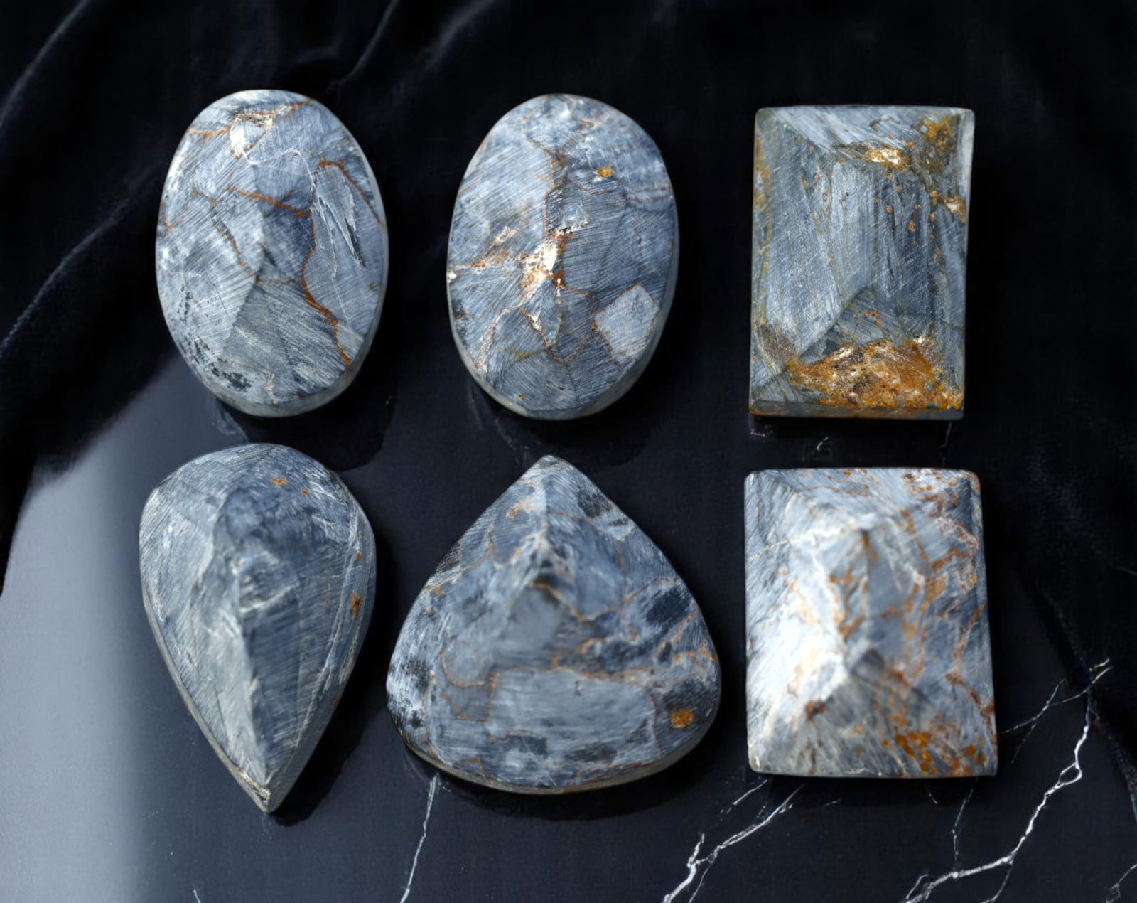 NAMIBIAN PIETERSITE: Preform Cabochon Lot - Rough with Chatoyant Blue-Grey Swirls (Avg. 10-15mm): A dramatic selection of pre-shaped Pietersite cabochon rough, sourced from Namibia and exhibiting the signature stormy swirls and fibrous chatoyance of this rare quartz variant. These polished preform