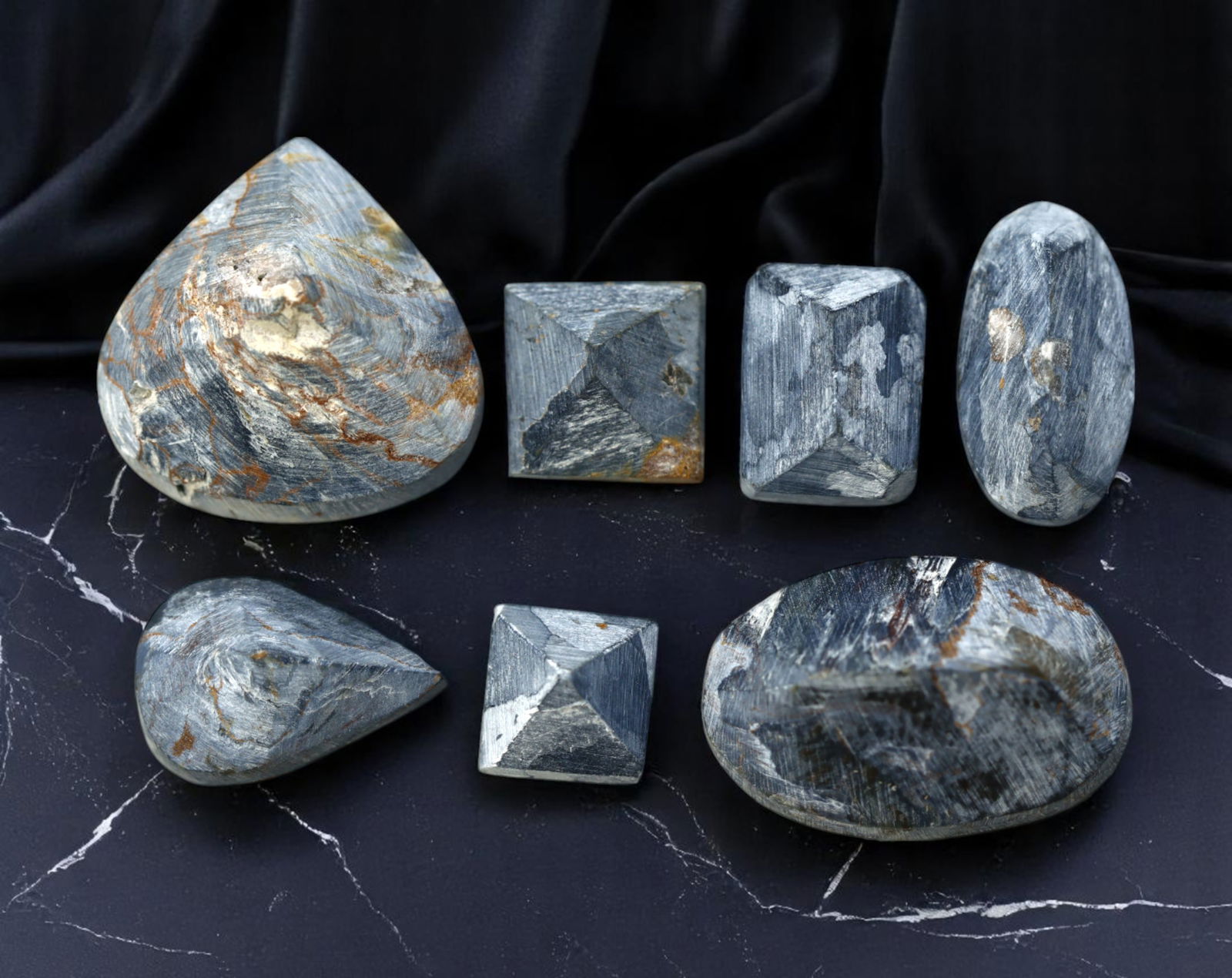 NAMIBIAN PIETERSITE: Preform Cabochon Lot - Rough with Chatoyant Blue-Grey Swirls (Avg. 10-15mm): A dramatic selection of pre-shaped Pietersite cabochon rough, sourced from Namibia and exhibiting the signature stormy swirls and fibrous chatoyance of this rare quartz variant. These polished preform