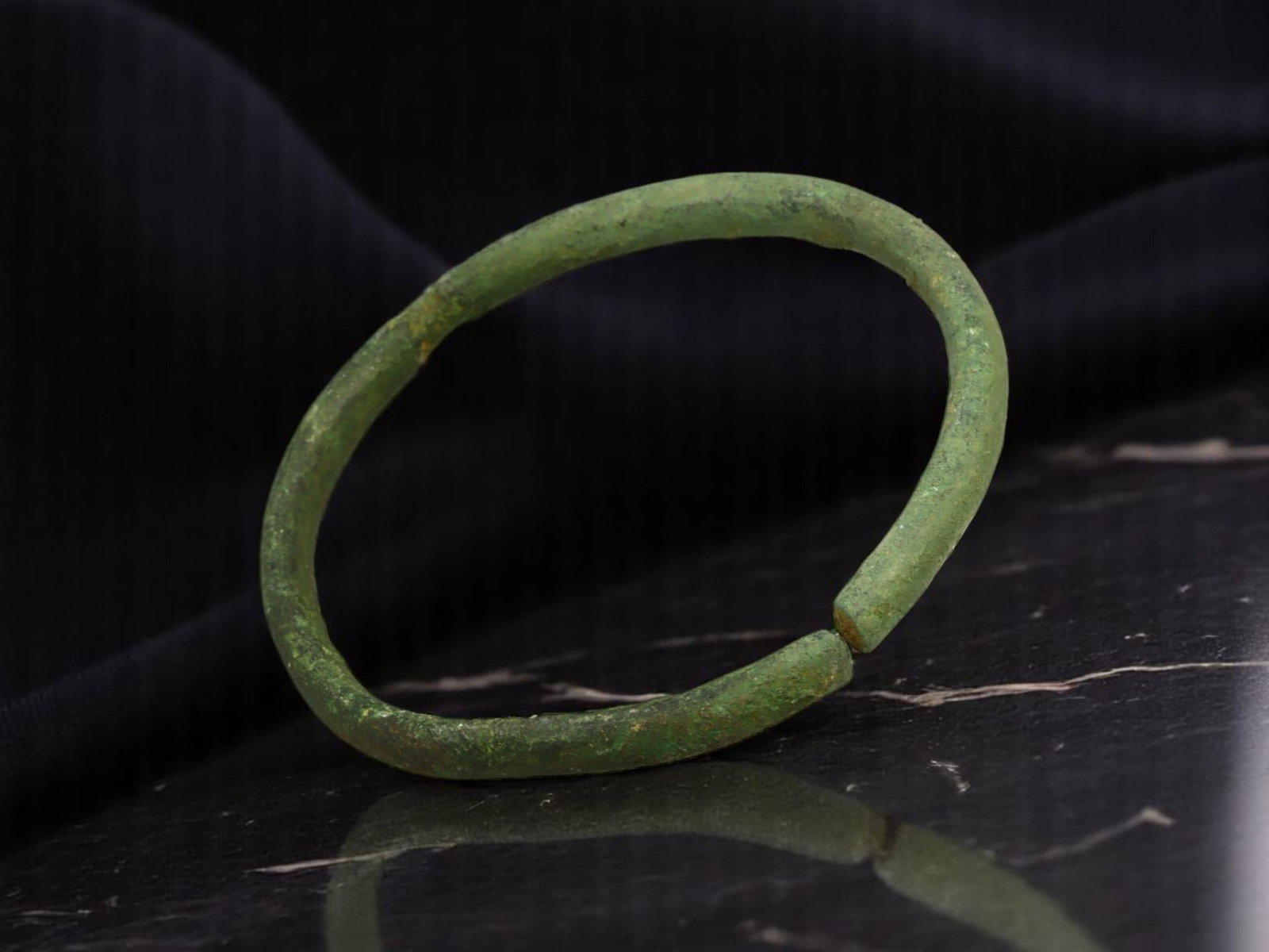 CELTIC PROTO-CURRENCY Ring - Slender Loop with Subtle Tool Marks (4.7 cm): A well-preserved example of Iron Age economic utility, this 4.7 cm trade ring features a narrow gauge with slight hand tooling evident near the ends. The contour retains its original integrity with on