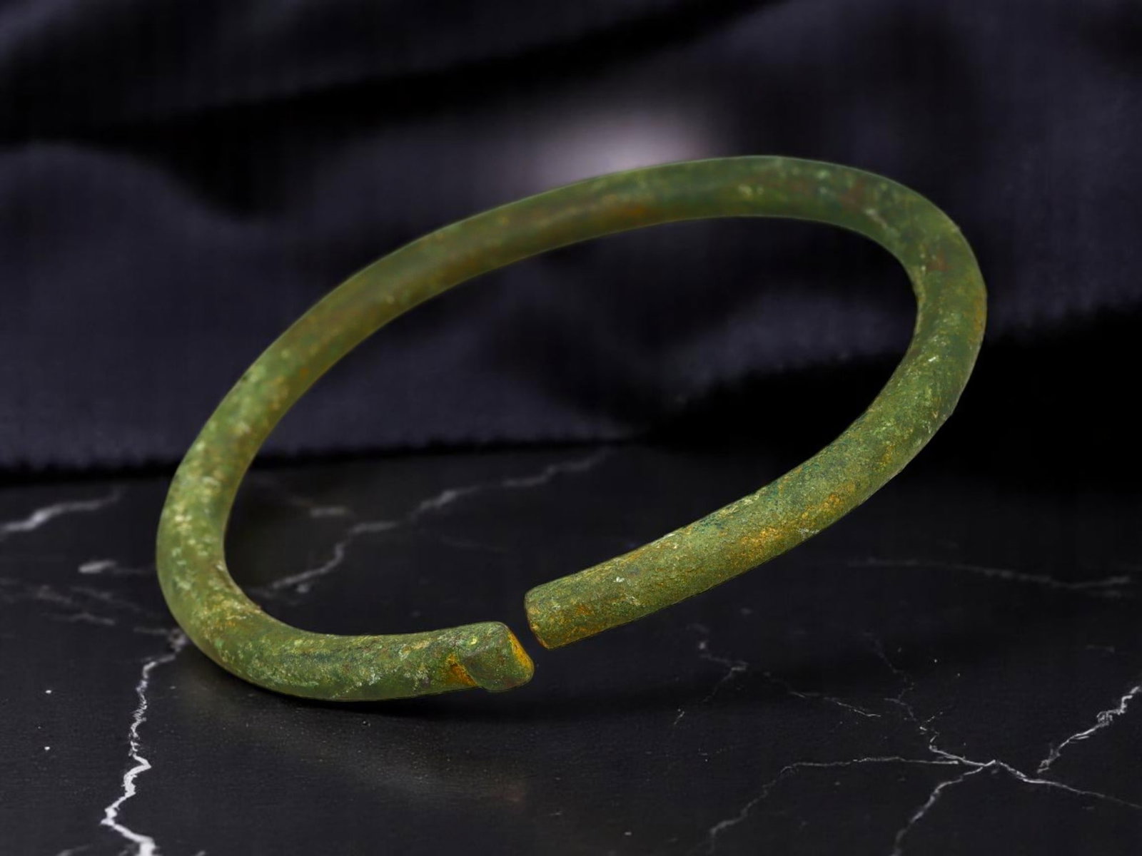 CELTIC BRONZE Open-Ended Bracelet - Minimalist Round Profile, 5.8 cm: Subtle yet steeped in cultural legacy, this 5.8 cm Celtic bronze bracelet features a clean cylindrical form with a faintly flared terminal, lightly oxidized in mottled green and ochre tones. Its unemb