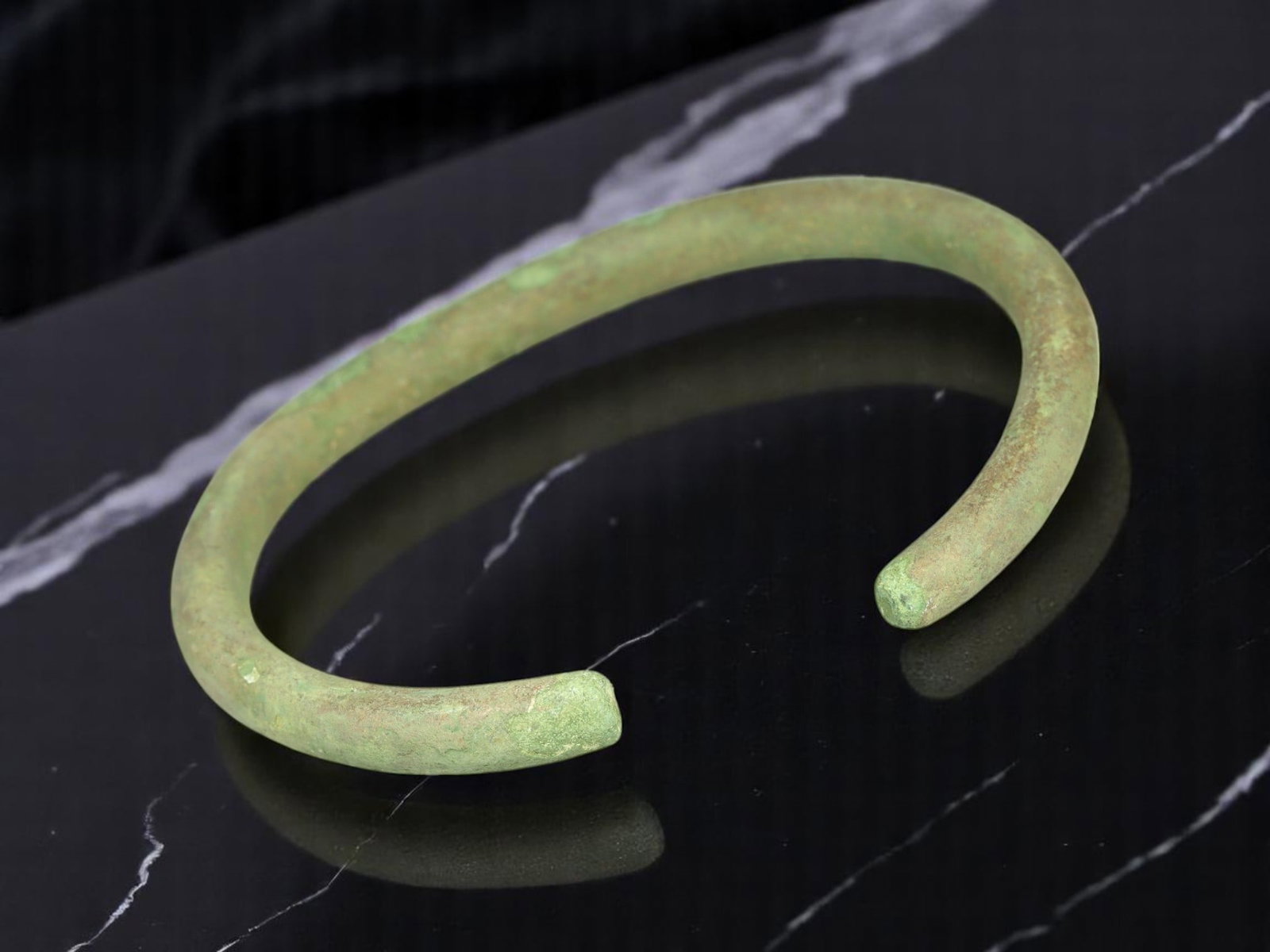 PROTO-CELTIC Bronze Trade Ring - Smoothly Tapered Form with Pale Green Patina (7.4 cm): Presenting a sleek 7.4 cm proto-Celtic bronze arm ring with a soft matte verdigris finish and clean, tapering terminals. This example stands out for its even curvature and minimal corrosion, suggestin