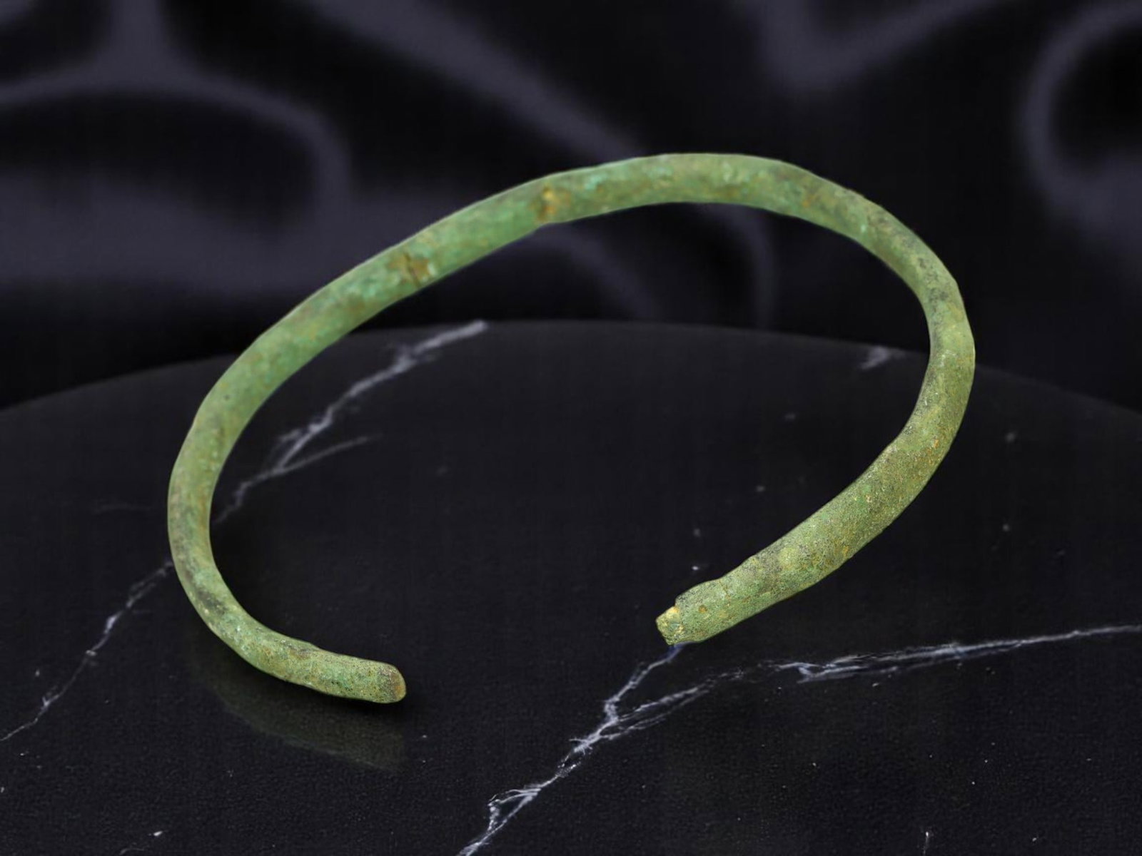 CELTIC Open-Ended Tapered Bronze Armlet with Light Verdigris, 6.4 cm: A slender and tactile example of early European personal adornment, this Celtic bronze bracelet features a tapering open-ended form forged in a continuous band. Measuring 6.4 cm in diameter, the piece