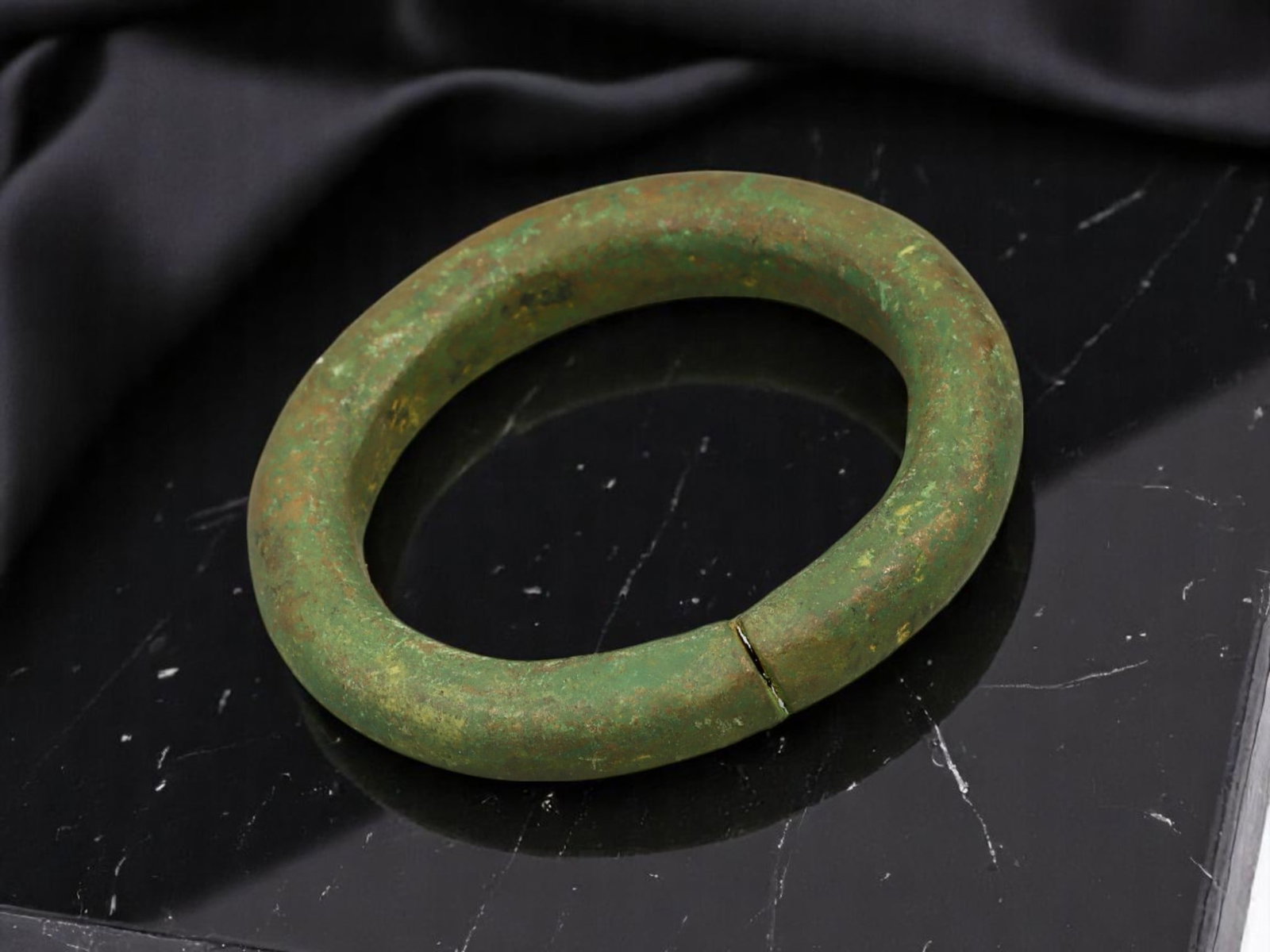 PROTO-CELTIC Solid-Cast Closed Bronze Ring with Wide Rounded Profile, 3.7 cm: A compact and weighty form, this Proto-Celtic solid bronze ring features a closed circular design with a thickened, rounded profile. At just 3.7 cm in diameter, the piece suggests use as a proto-curre