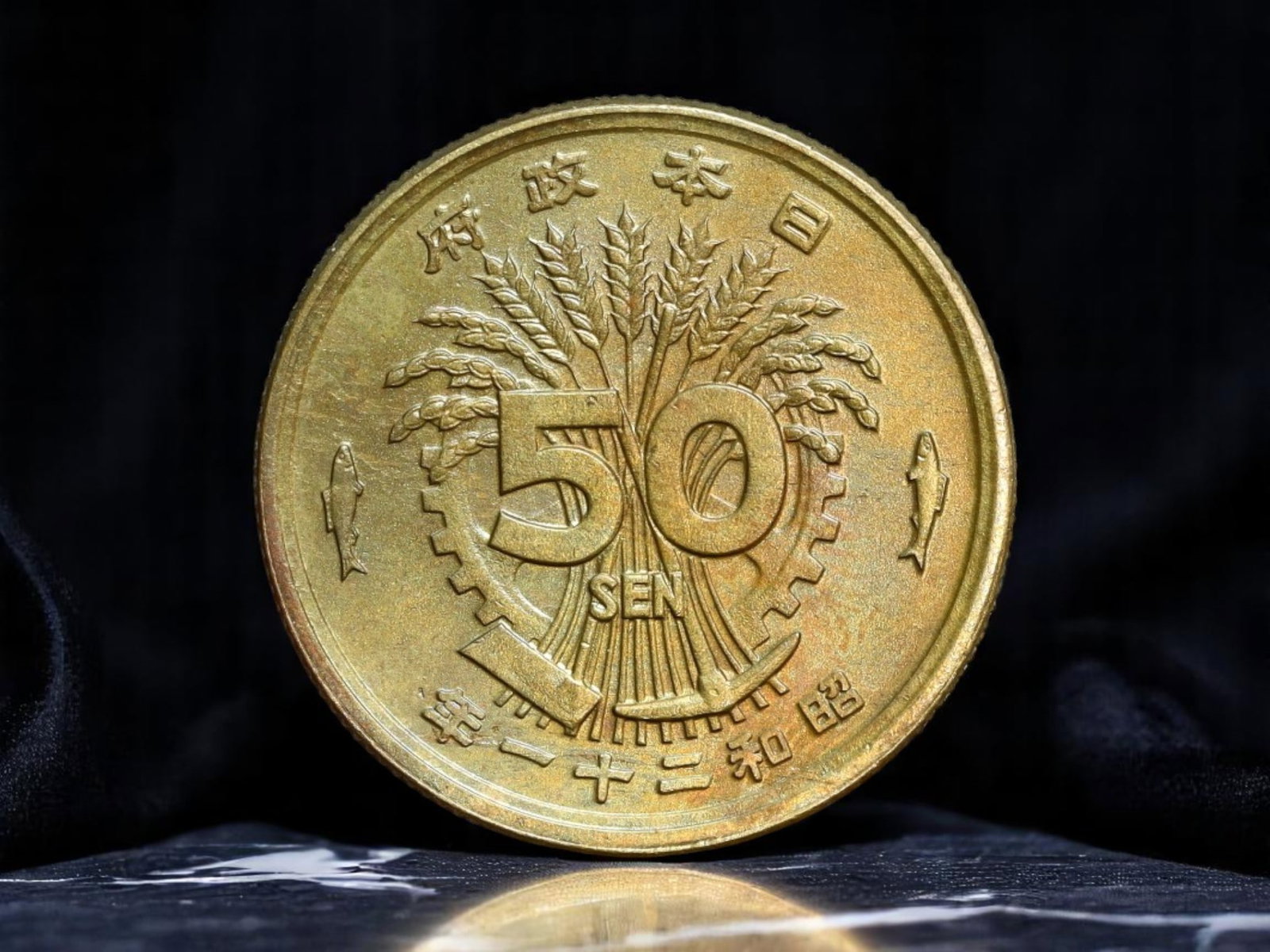 JAPAN: Showa Era - Industrial Harmony 50 Sen Coin, Year 15 (1940), 23mm: Struck during the pivotal 15th year of Emperor Hirohito's reign, this 50 Sen coin captures Japan's ideological fusion of tradition and modernization on the eve of total war. The obverse design emphasi
