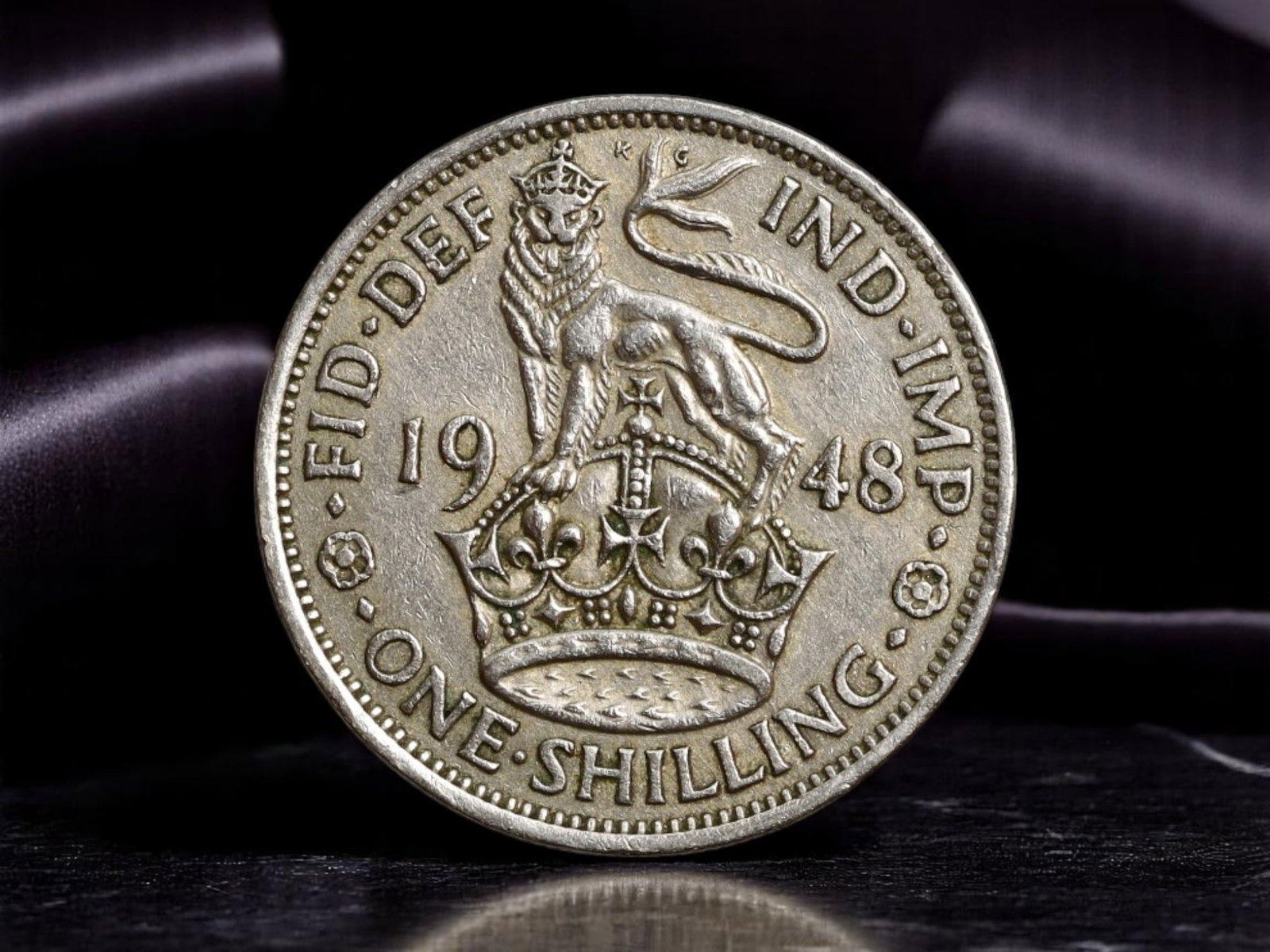 UNITED KINGDOM: George VI - Imperial Authority One Shilling Coin, 1948, 24mm: Minted in the wake of World War II, this 1948 one shilling coin bearing the effigy of King George VI symbolizes Britain's enduring imperial presence and monarchical continuity amid global change. The 