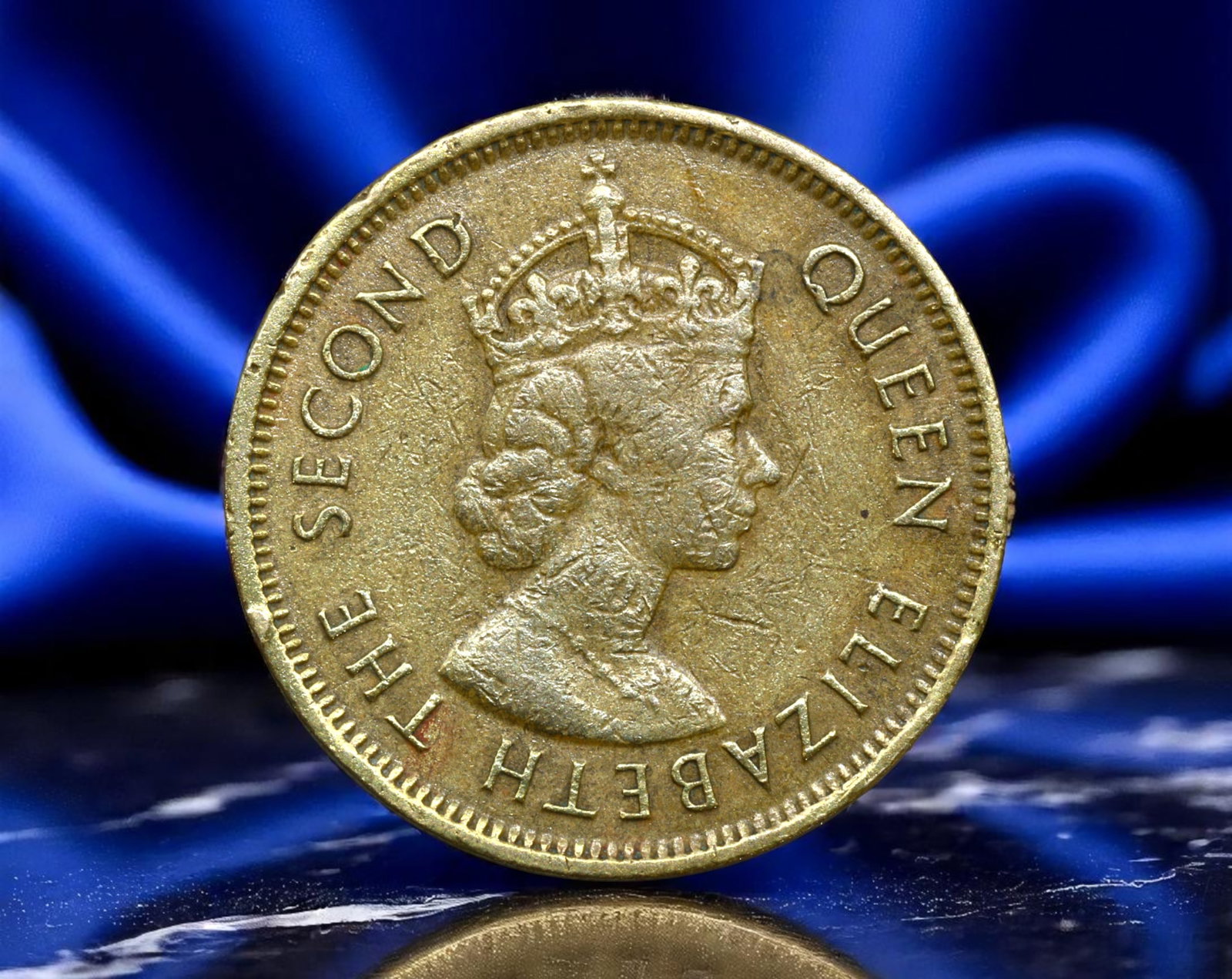 HONG KONG: Queen Elizabeth II - Colonial Sovereignty Ten Cents Coin, 1964, 20mm: Issued during the height of British colonial governance in Asia, this 1964 Hong Kong Ten Cents coin bears the crowned portrait of a youthful Queen Elizabeth II, projecting the enduring reach of imperi
